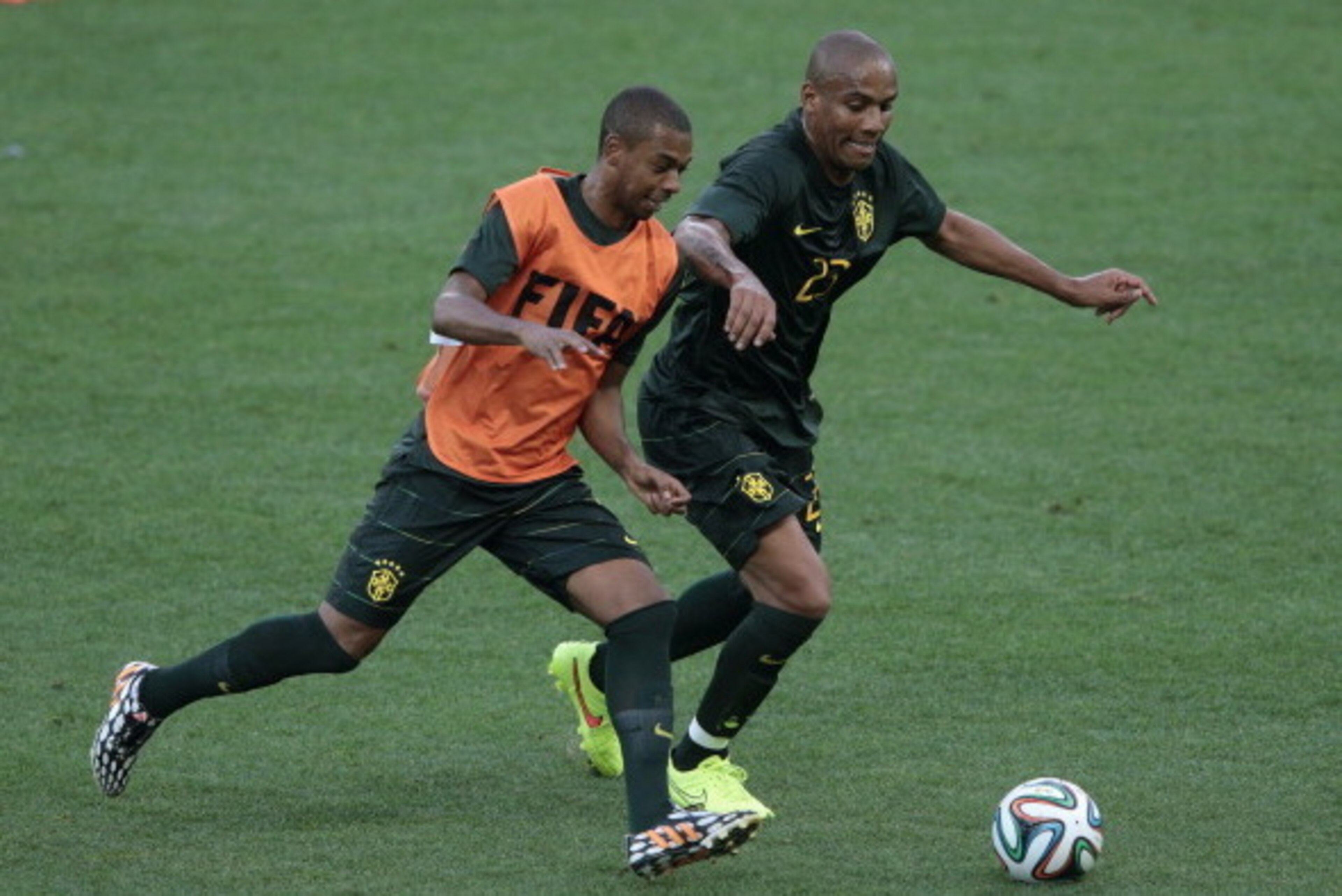 SAO PAULO, BRAZIL - JUNE 11: Fernandinho (L) challenges Maicon of Brazil during a Brazil training session ahead of the 2014 FIFA World Cup Brazil opening match against Croatia at Arena de Sao Paulo on June 11, 2014 in Sao Paulo, Brazil.  (Photo by Adam Pr