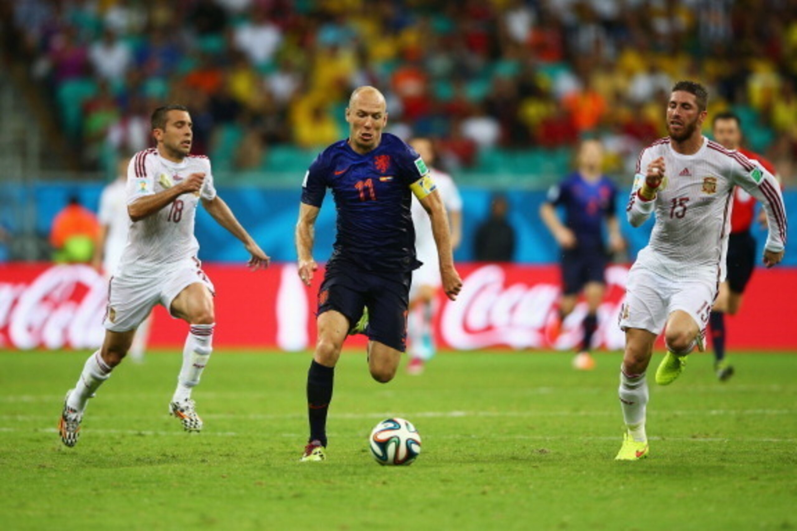 SALVADOR, BRAZIL - JUNE 13: Arjen Robben of the Netherlands beats Sergio Ramos and Jordi Alba during the 2014 FIFA World Cup Brazil Group B match between Spain and Netherlands at Arena Fonte Nova on June 13, 2014 in Salvador, Brazil. (Photo by Paul Gilh SALVADOR, BRAZIL - JUNE 13: Arjen Robben of the Netherlands beats Sergio Ramos and Jordi Alba during the 2014 FIFA World Cup Brazil Group B match between Spain and Netherlands at Arena Fonte Nova on June 13, 2014 in Salvador, Brazil. (Photo by Paul Gilh