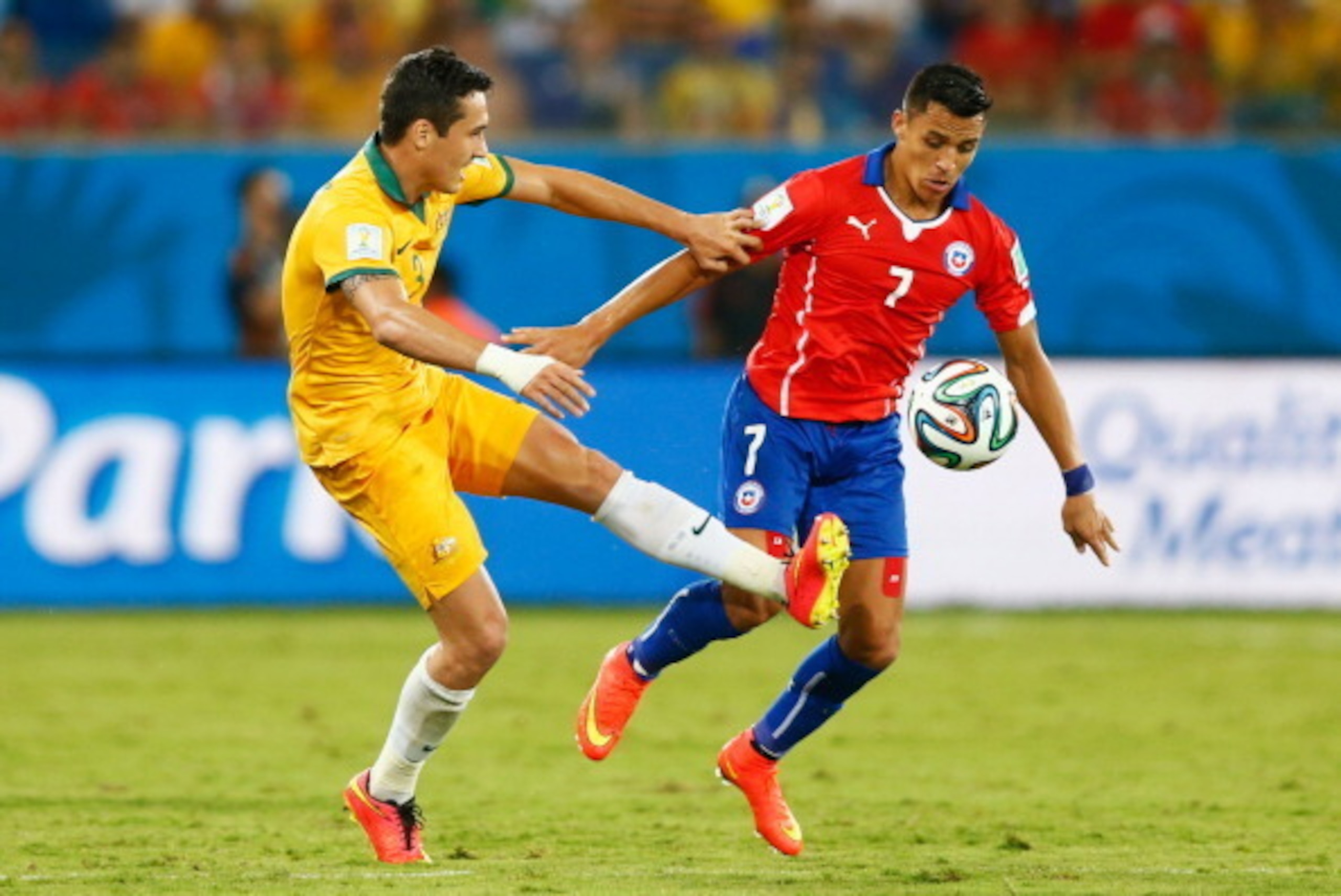 CUIABA, BRAZIL - JUNE 13: Alexis Sanchez of Chile holds off Jason Davidson of Australia during the 2014 FIFA World Cup Brazil Group B match between Chile and Australia at Arena Pantanal on June 13, 2014 in Cuiaba, Brazil. (Photo by Phil Walter/Getty Ima CUIABA, BRAZIL - JUNE 13: Alexis Sanchez of Chile holds off Jason Davidson of Australia during the 2014 FIFA World Cup Brazil Group B match between Chile and Australia at Arena Pantanal on June 13, 2014 in Cuiaba, Brazil. (Photo by Phil Walter/Getty Ima
