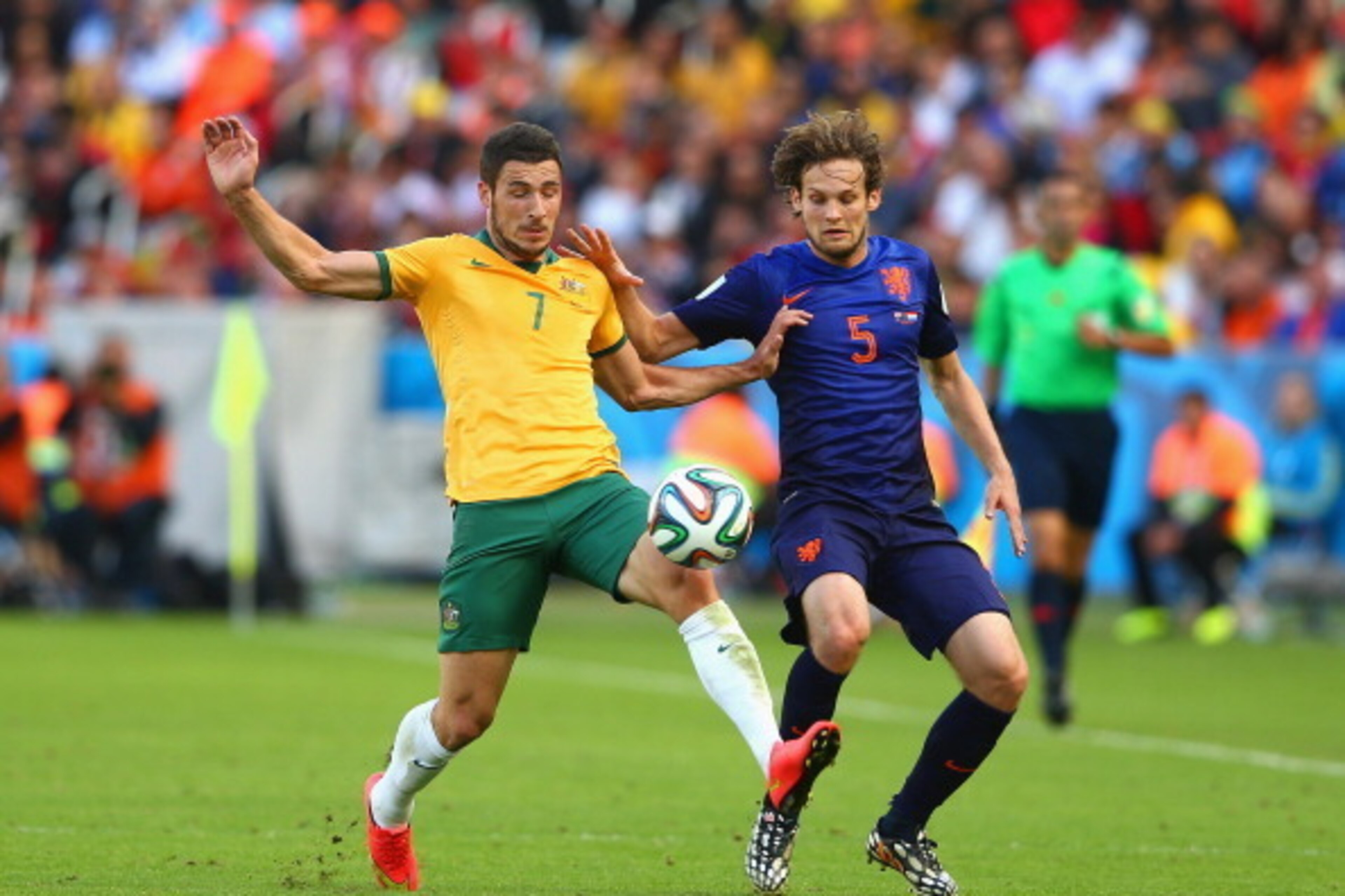 PORTO ALEGRE, BRAZIL - JUNE 18: Mathew Leckie of Australia competes for the ball with Daley Blind of the Netherlands during the 2014 FIFA World Cup Brazil Group B match between Australia and Netherlands at Estadio Beira-Rio on June 18, 2014 in Porto Alegr PORTO ALEGRE, BRAZIL - JUNE 18: Mathew Leckie of Australia competes for the ball with Daley Blind of the Netherlands during the 2014 FIFA World Cup Brazil Group B match between Australia and Netherlands at Estadio Beira-Rio on June 18, 2014 in Porto Alegr