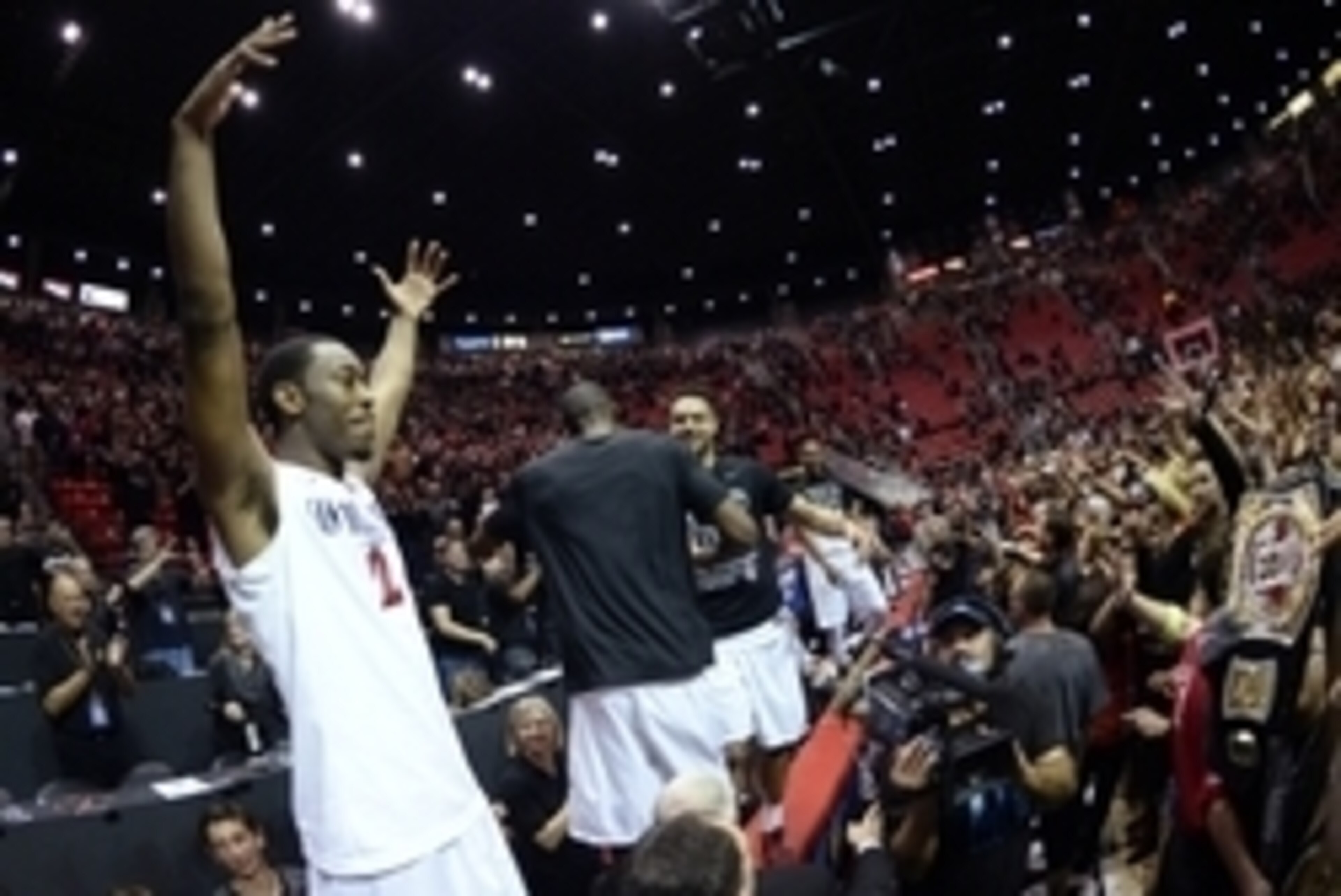 Mar 8, 2014; San Diego, CA, USA; San Diego State Aztecs guard Xavier Thames (2) celebrates on the scorers table after a win against the New Mexico Lobos at Viejas Arena. The Aztecs won 51-48 to claim the regular season Mountain West championship. Mandator
