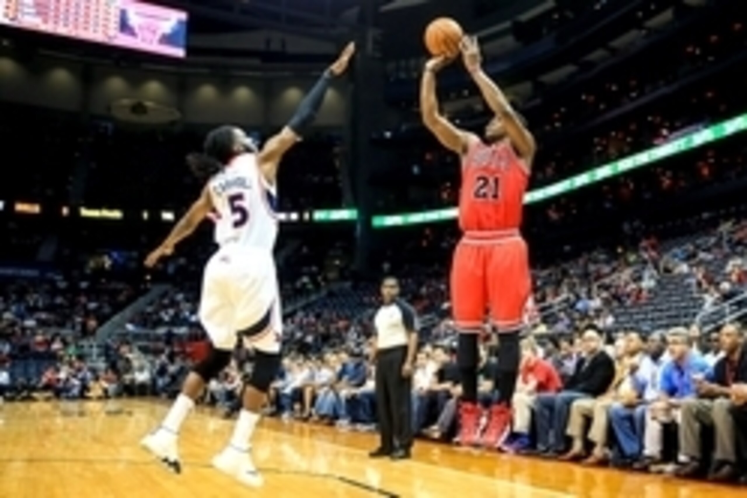 Apr 2, 2014; Atlanta, GA, USA; Chicago Bulls guard Jimmy Butler (21) shoots a three over Atlanta Hawks forward DeMarre Carroll (5) in the first half at Philips Arena. Mandatory Credit: Daniel Shirey-USA TODAY Sports