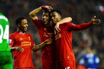 LIVERPOOL, ENGLAND - JANUARY 28:  Daniel Sturridge (R) of Liverpool is congratulated by teammates Luis Suarez (C) and Raheem Sterling (L) after scoring his team's third goal as dejected Everton goalkeeper Tim Howard looks on during the Barclays Premier Le