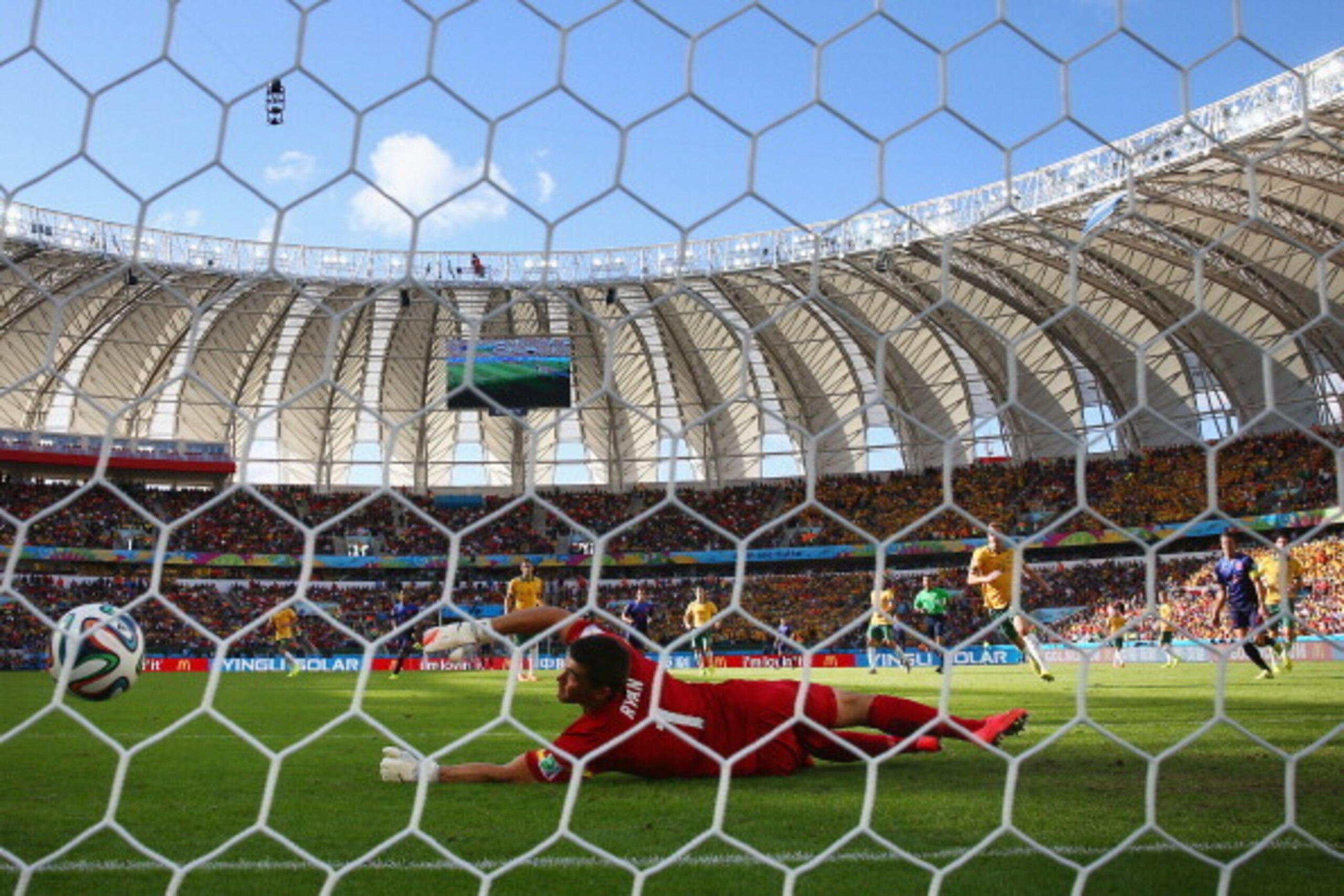 PORTO ALEGRE, BRAZIL - JUNE 18: Memphis Depay of the Netherlands shoots and scores his team's third goal past Mathew Ryan of Australia during the 2014 FIFA World Cup Brazil Group B match between Australia and Netherlands at Estadio Beira-Rio on June 18, 2
