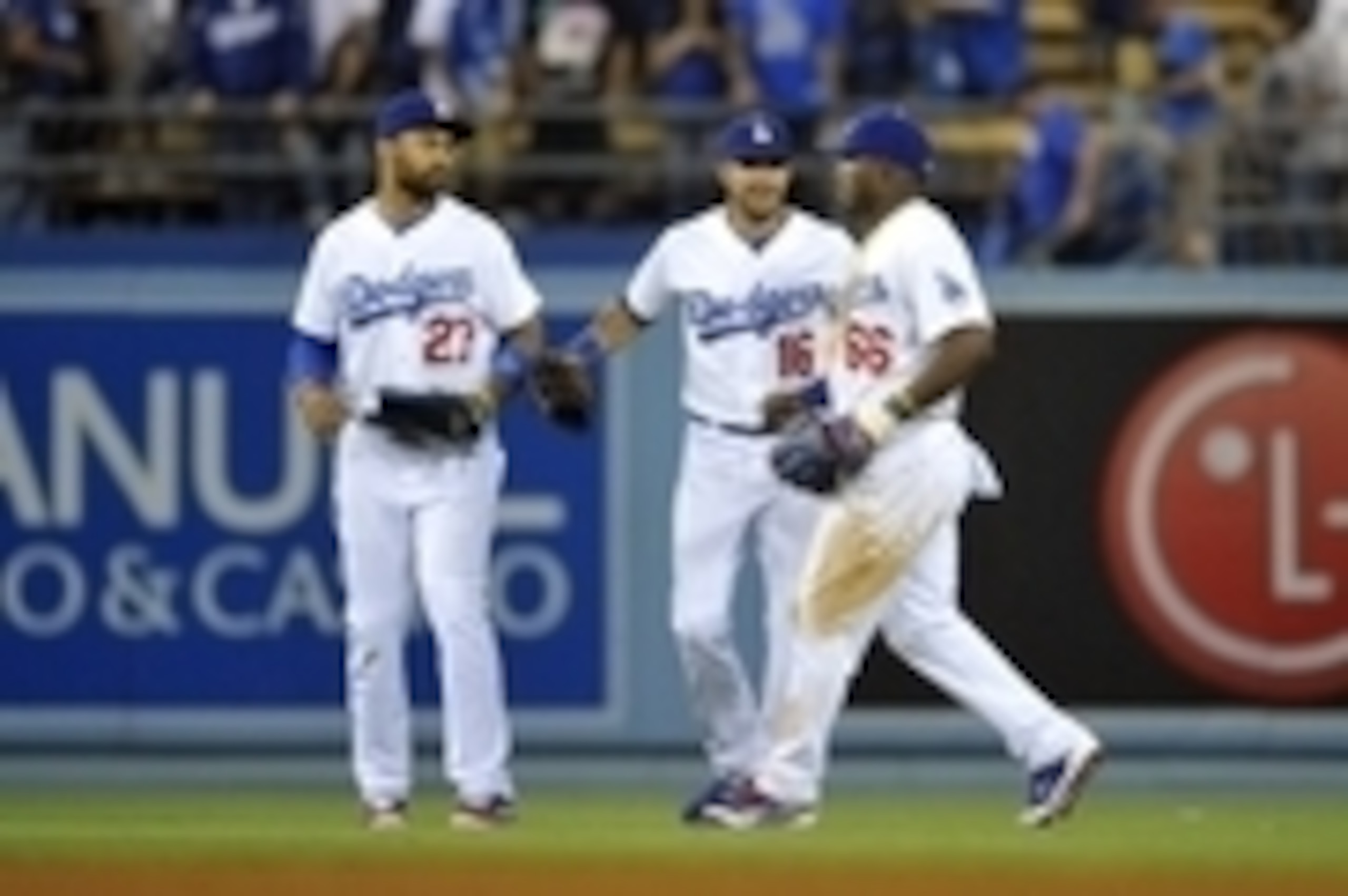 June 14, 2014; Los Angeles, CA, USA; Los Angeles Dodgers center fielder Matt Kemp (27), center fielder Andre Ethier (16) and right fielder Yasiel Puig (66) celebrate the 6-4 victory against the Arizona Diamondbacks at Dodger Stadium. Mandatory Credit: Gar