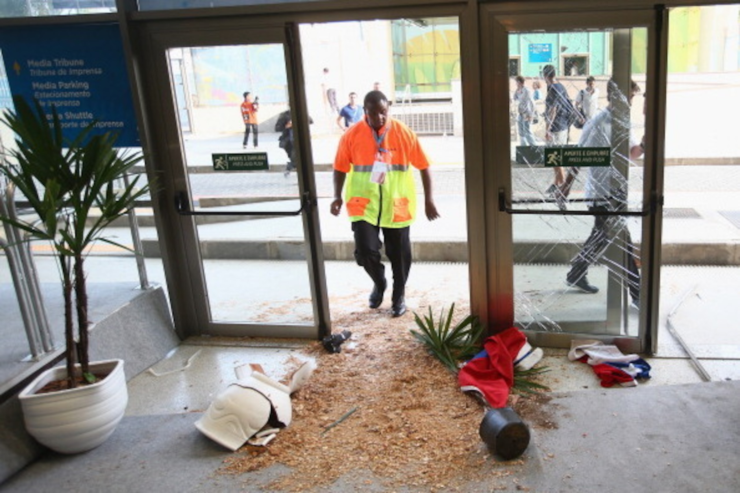 RIO DE JANEIRO, BRAZIL - JUNE 18:  Security personnel stand near broken doors and planters after fans broke through security entering the stadium prior to the 2014 FIFA World Cup Brazil Group B match between Spain and Chile at Maracana on June 18, 2014 in