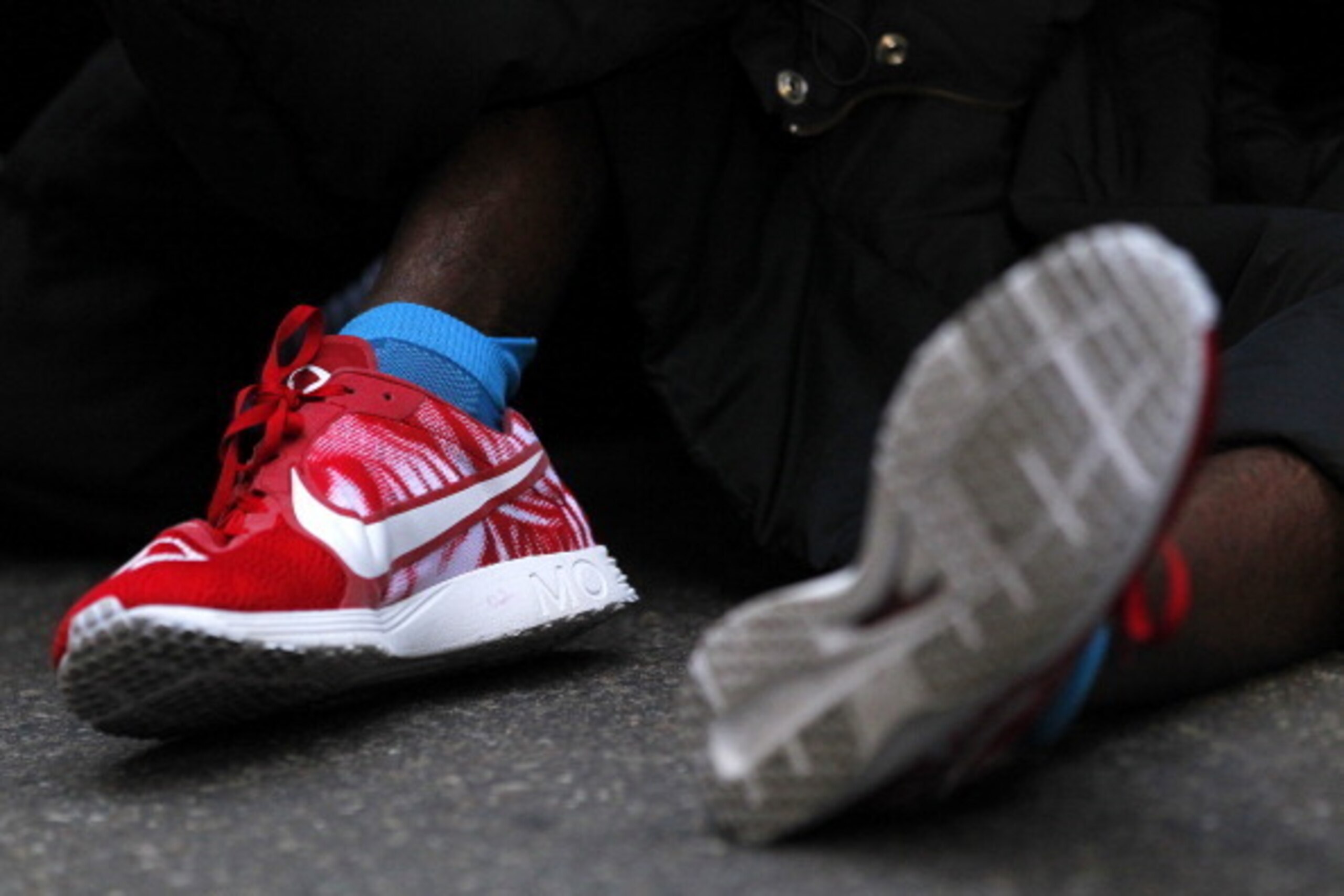 NEW YORK, NY - MARCH 16: A detail of Mo Farah of Great Britain's personalised trainers as he is taken care of by medical personal after he collapsed at the finish line after finishing in second place at the 2014 New York City Half Marathon in lower Manhat