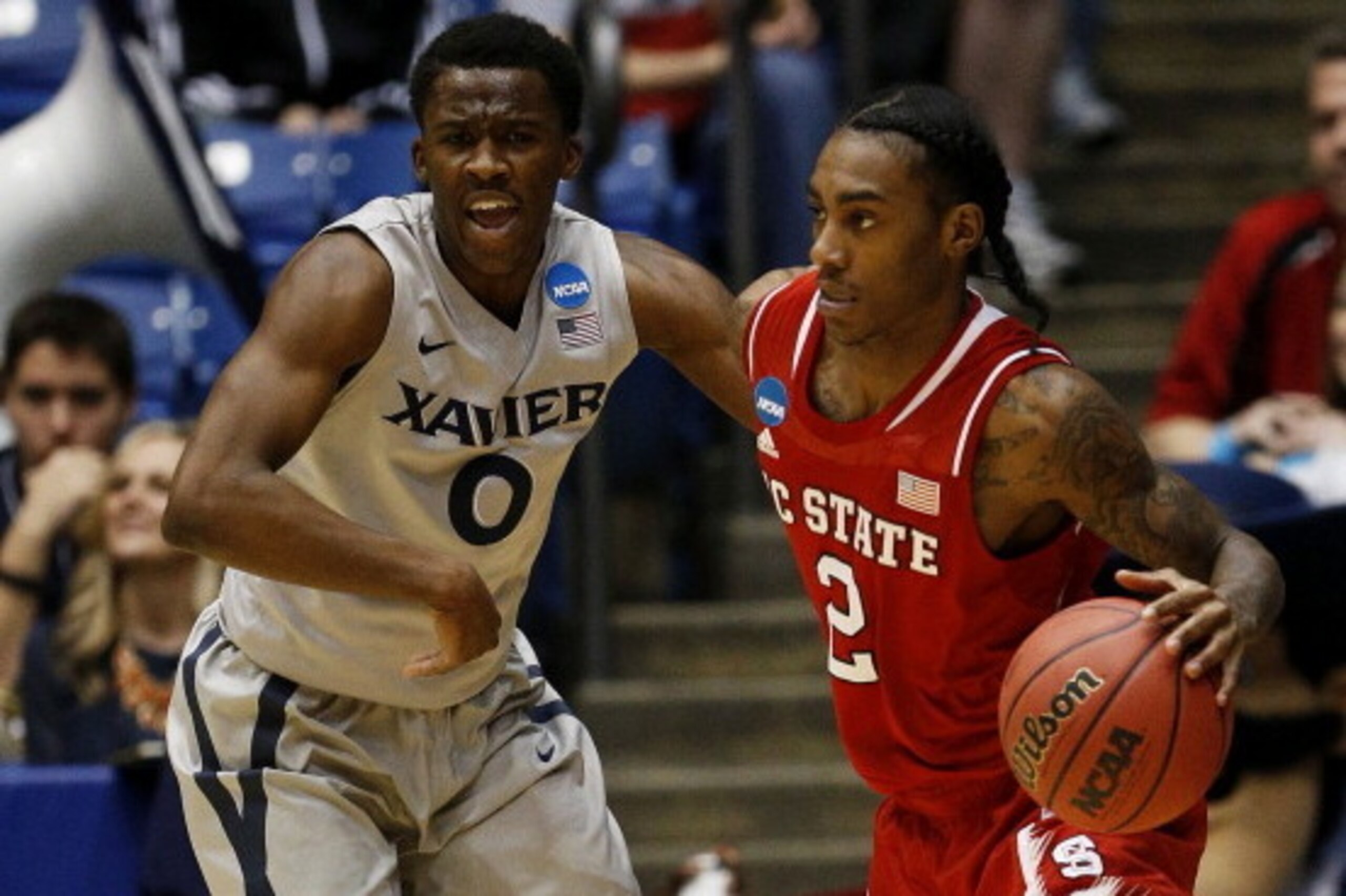 DAYTON, OH - MARCH 18:  Anthony Barber #2 of the North Carolina State Wolfpack drives against Semaj Christon #0 of the Xavier Musketeers in the first half during the first round of the 2014 NCAA Men's Basketball Tournament at at University of Dayton Arena