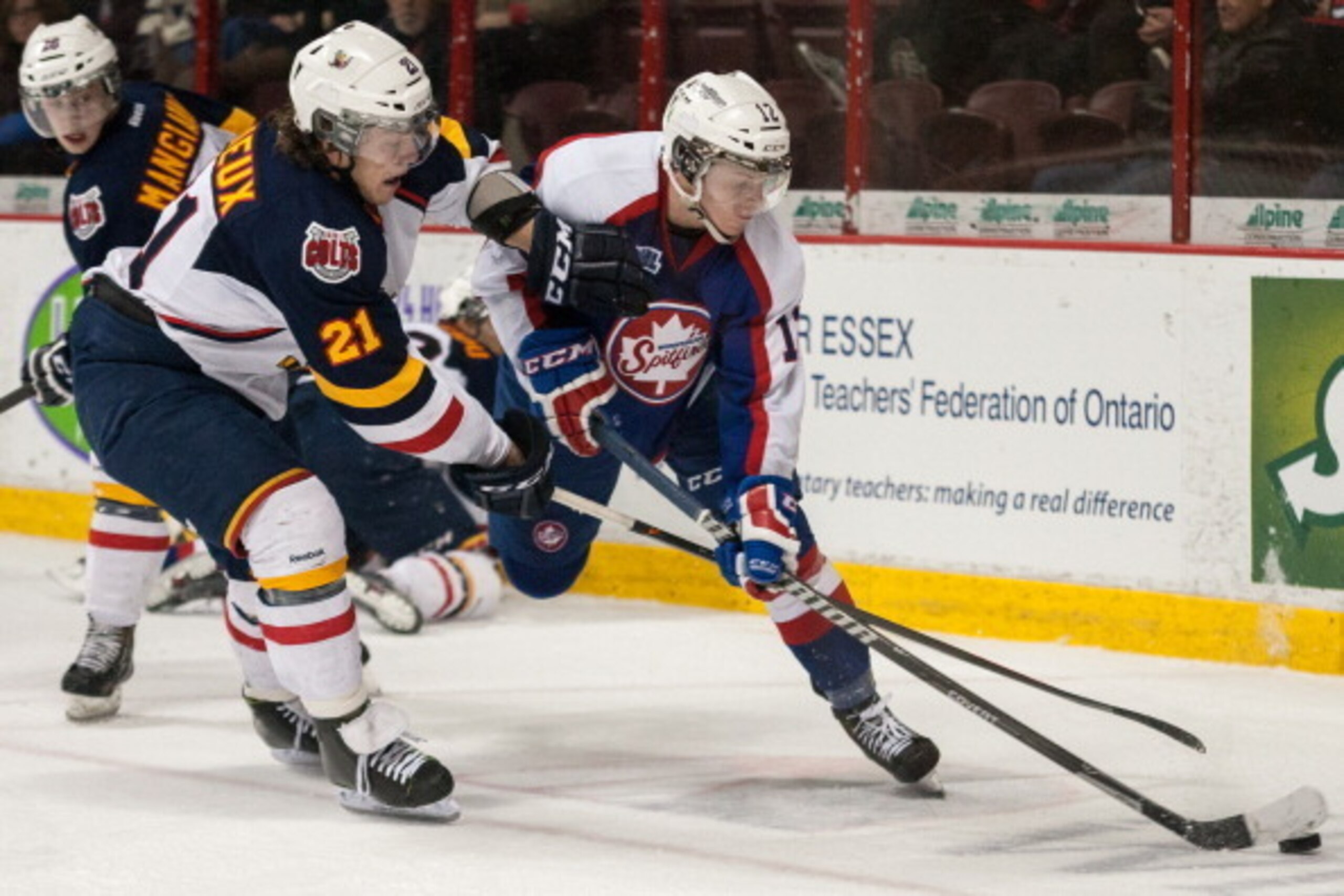 WINDSOR, ON - FEBRUARY 27: Brendan Lemieux #21 of the Barrie Colts battles for the puck against Ben Johnson #12 of the Windsor Spitfires on February 27, 2014 at the WFCU Centre in Windsor, Ontario, Canada. (Photo by Dennis Pajot/Getty Images)