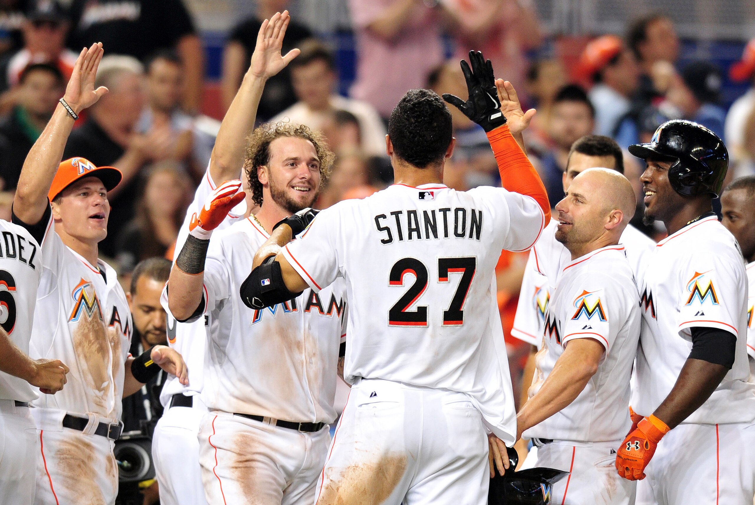 Apr 18, 2014; Miami, FL, USA; Miami Marlins right fielder Giancarlo Stanton (27) celebrates with teammates after hitting a grand slam to win the game 8-4 against the Seattle Mariners at Marlins Ballpark. Mandatory Credit: Steve Mitchell-USA TODAY Sports