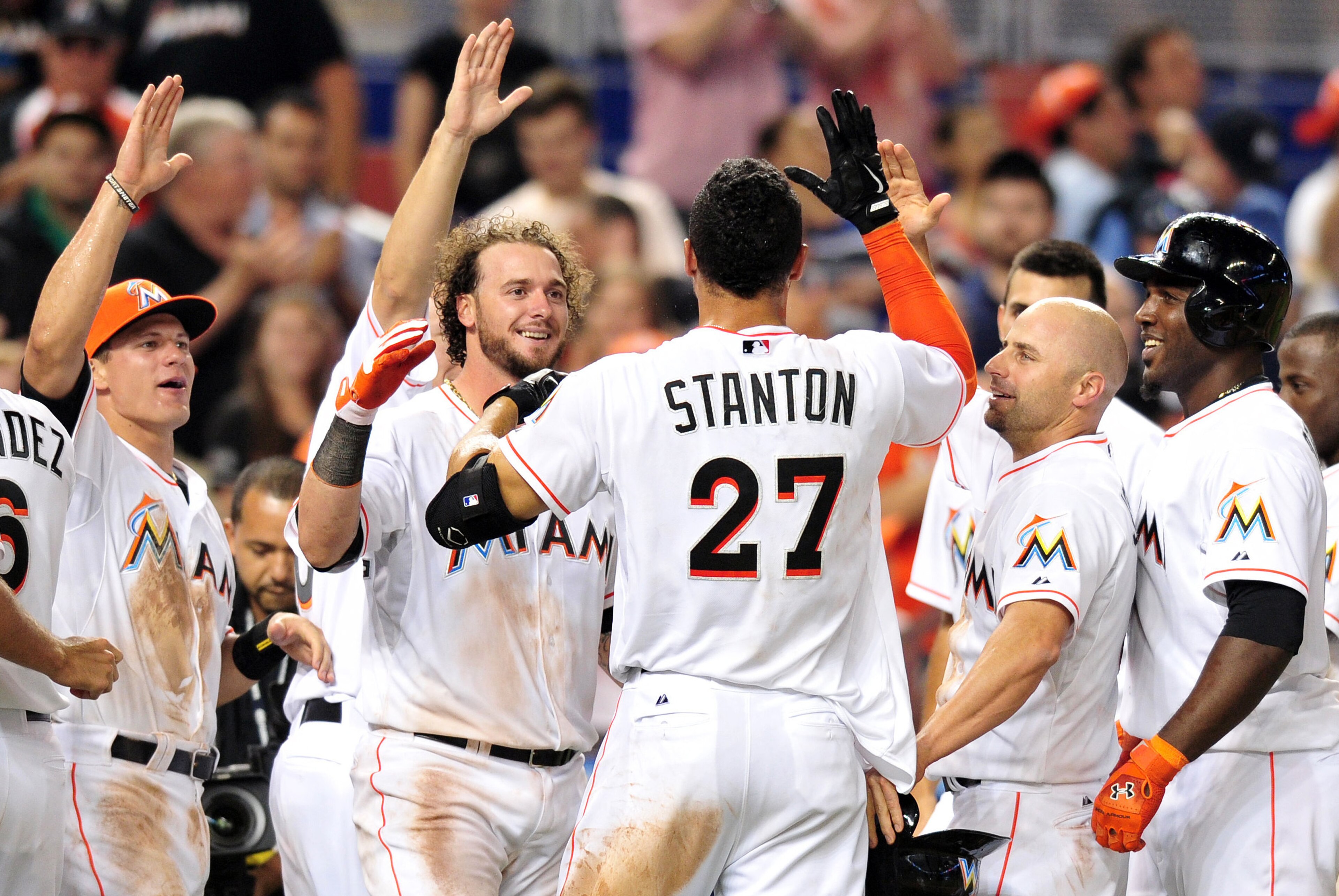 Apr 18, 2014; Miami, FL, USA; Miami Marlins right fielder Giancarlo Stanton (27) celebrates with teammates after hitting a grand slam to win the game 8-4 against the Seattle Mariners at Marlins Ballpark. Mandatory Credit: Steve Mitchell-USA TODAY Sports