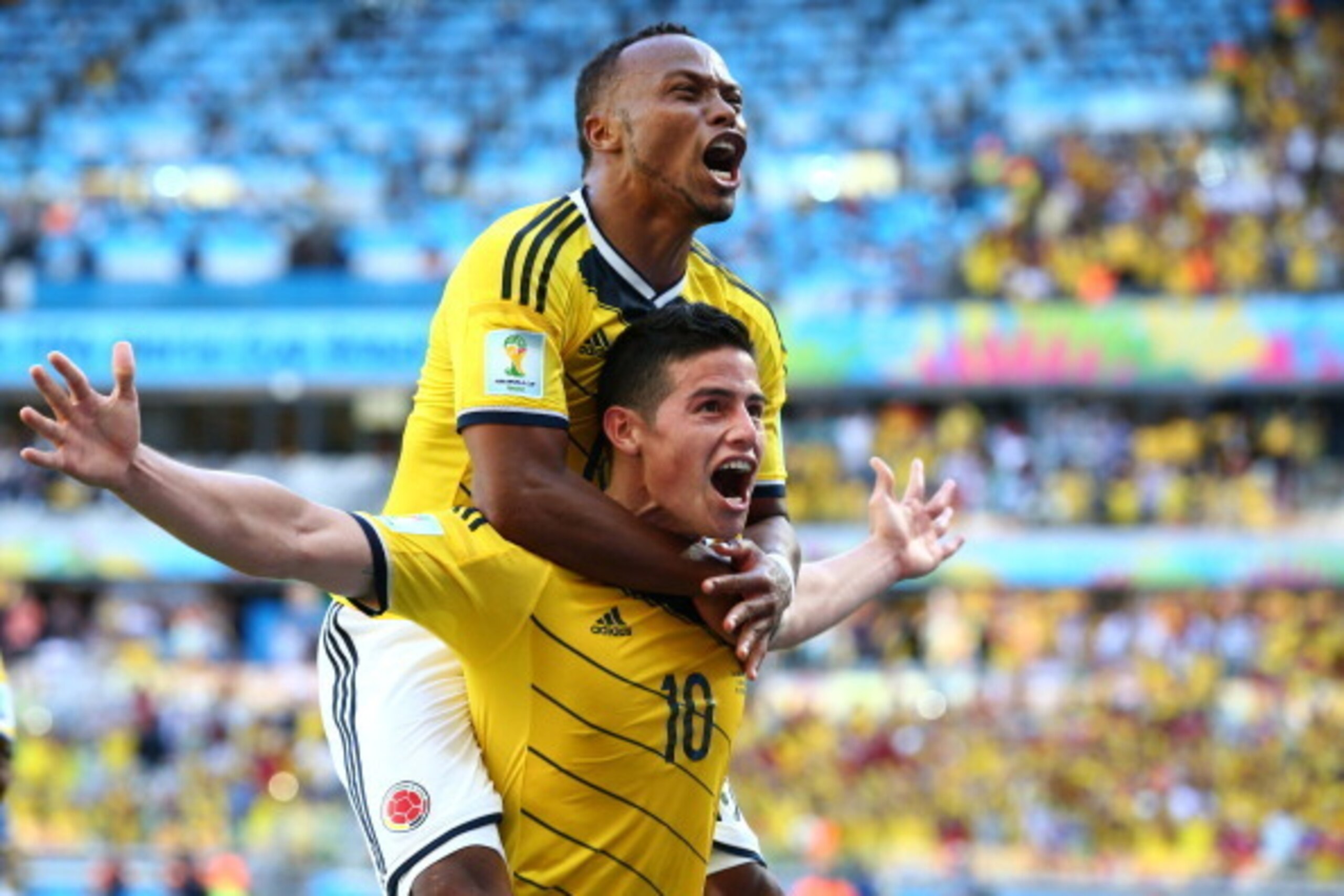 BELO HORIZONTE, BRAZIL - JUNE 14: James Rodriguez of Colombia celebrates scoring his team's third goal with Juan Camilo Zuniga during the 2014 FIFA World Cup Brazil Group C match between Colombia and Greece at Estadio Mineirao on June 14, 2014 in Belo Hor