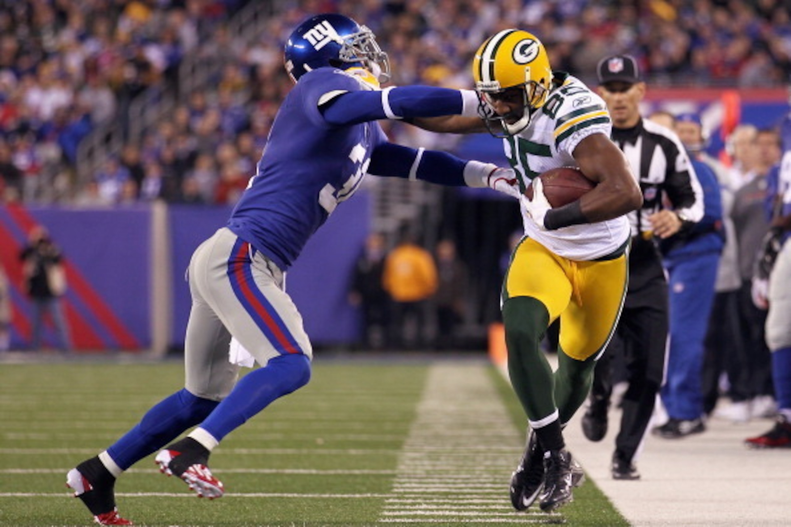 EAST RUTHERFORD, NJ - DECEMBER 04: Greg Jennings #85 of the Green Bay Packers runs for yards after the catch in the first quarter against Aaron Ross #31 of the New York Giants at MetLife Stadium on December 4, 2011 in East Rutherford, New Jersey. (Photo EAST RUTHERFORD, NJ - DECEMBER 04: Greg Jennings #85 of the Green Bay Packers runs for yards after the catch in the first quarter against Aaron Ross #31 of the New York Giants at MetLife Stadium on December 4, 2011 in East Rutherford, New Jersey. (Photo