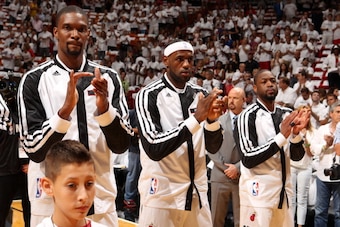 MIAMI, FL - MAY 6: Chris Bosh #1. LeBron James #6, and Dwyane Wade #3 of the Miami Heat stand for the national anthem before Game One of the Eastern Conference Semi-Finals against the Brooklyn Nets during the 2014 NBA Playoffs at American Airlines Arena o