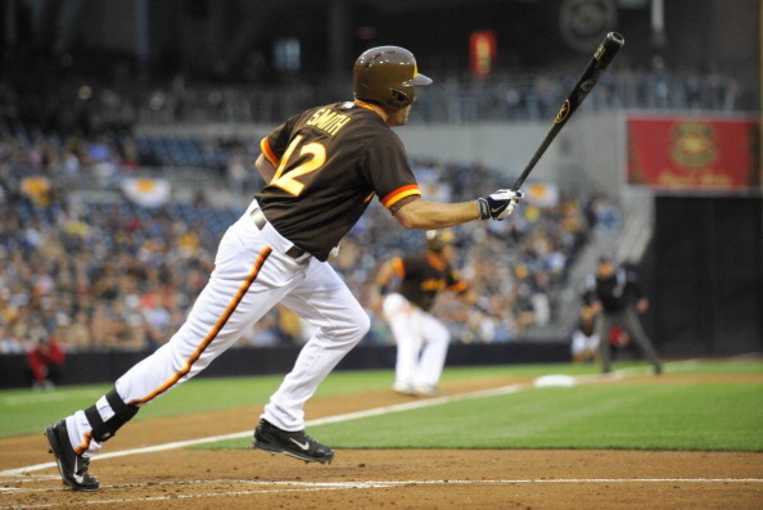 SAN DIEGO, CA - MAY 23: San Diego Padres left fielder Seth Smith #12 hits an RBI single during the first inning of a baseball game against the Chicago Cubs at Petco Park May 23, 2014 in San Diego, California. (Photo by Denis Poroy/Getty Images)