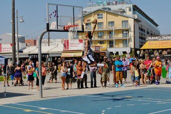 Fans watch a high-flying dunk at the Venice Basketball League.