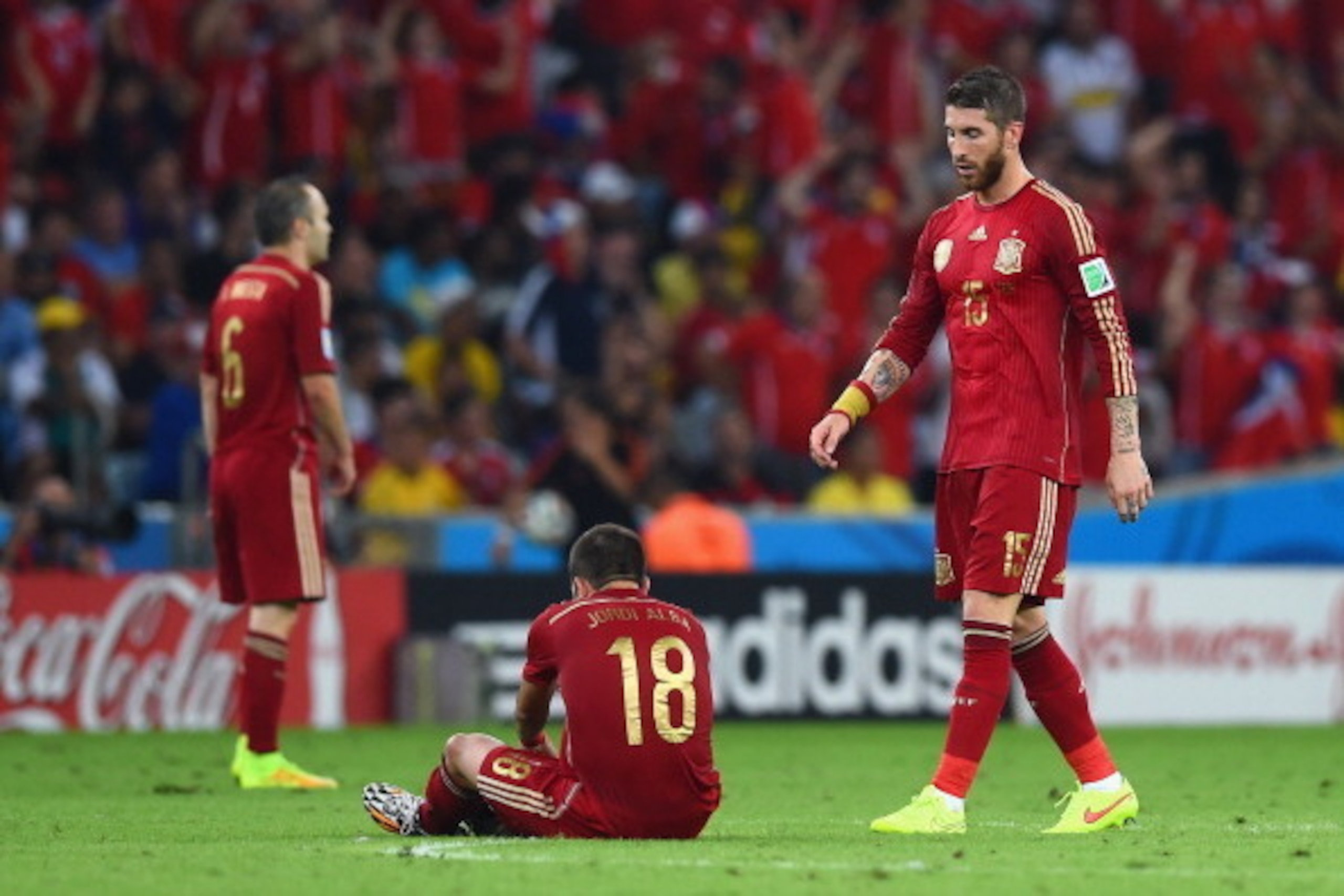 RIO DE JANEIRO, BRAZIL - JUNE 18:  Sergio Ramos of Spain looks on as teammate Jordi Alba fixes his boot during the 2014 FIFA World Cup Brazil Group B match between Spain and Chile at Maracana on June 18, 2014 in Rio de Janeiro, Brazil.  (Photo by Matthias