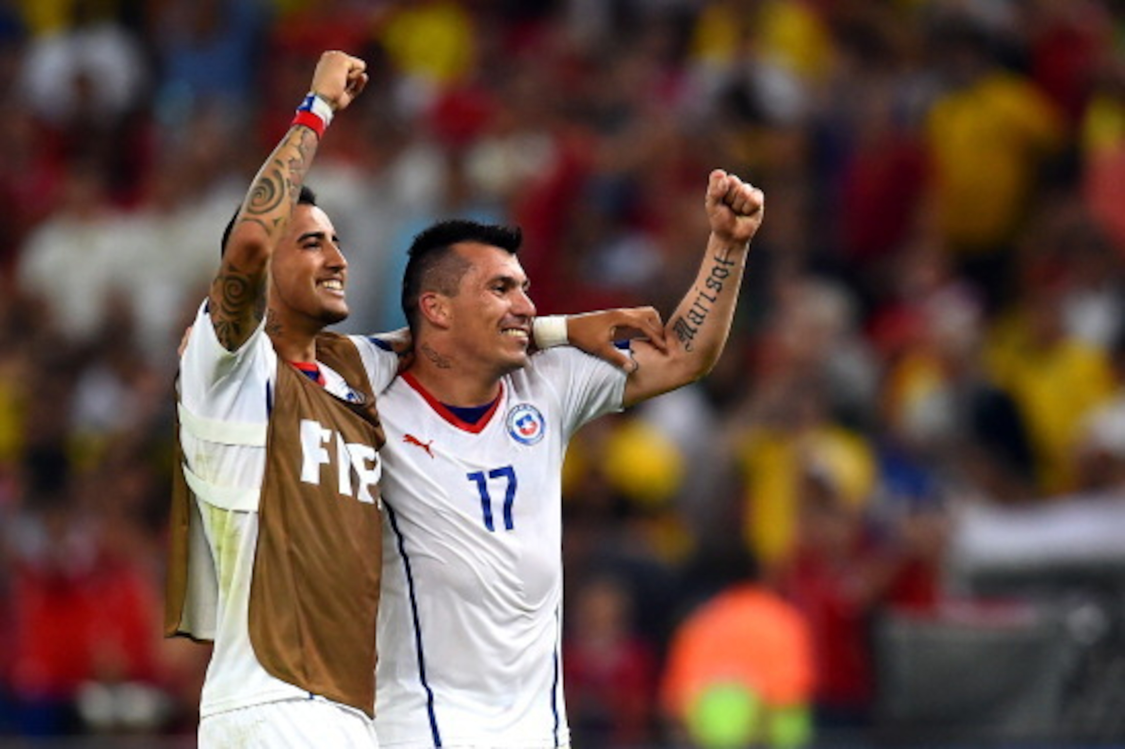 RIO DE JANEIRO, BRAZIL - JUNE 18:  Arturo Vidal and Gary Medel of Chile celebrate a 2-0 victory over Spain in the 2014 FIFA World Cup Brazil Group B match between Spain and Chile at Maracana on June 18, 2014 in Rio de Janeiro, Brazil.  (Photo by David Ram