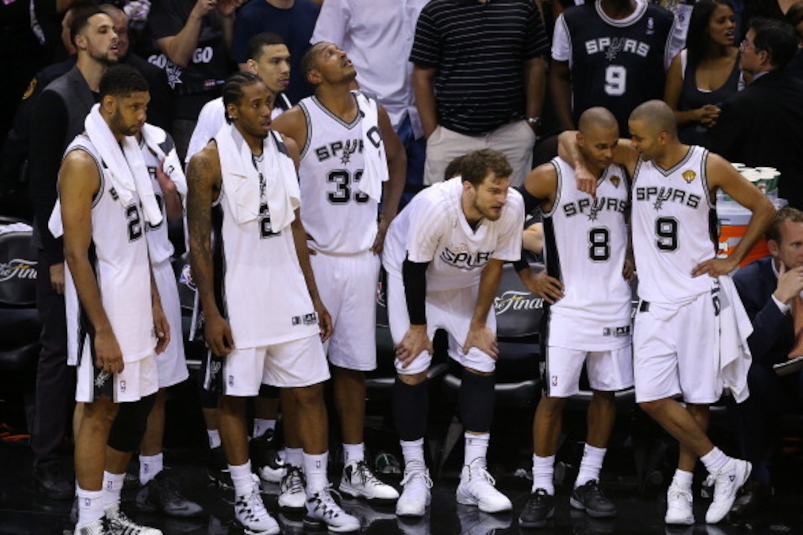 SAN ANTONIO, TX - JUNE 15: Tim Duncan #21, Kawhi Leonard #2, Danny Green #4, Boris Diaw #33, Tiago Splitter #22, Patty Mills #8 and Tony Parker #9 watch as their team defeat the Miami Heat in Game Five of the 2014 NBA Finals at the AT&T Center on June 15 SAN ANTONIO, TX - JUNE 15: Tim Duncan #21, Kawhi Leonard #2, Danny Green #4, Boris Diaw #33, Tiago Splitter #22, Patty Mills #8 and Tony Parker #9 watch as their team defeat the Miami Heat in Game Five of the 2014 NBA Finals at the AT&T Center on June 15