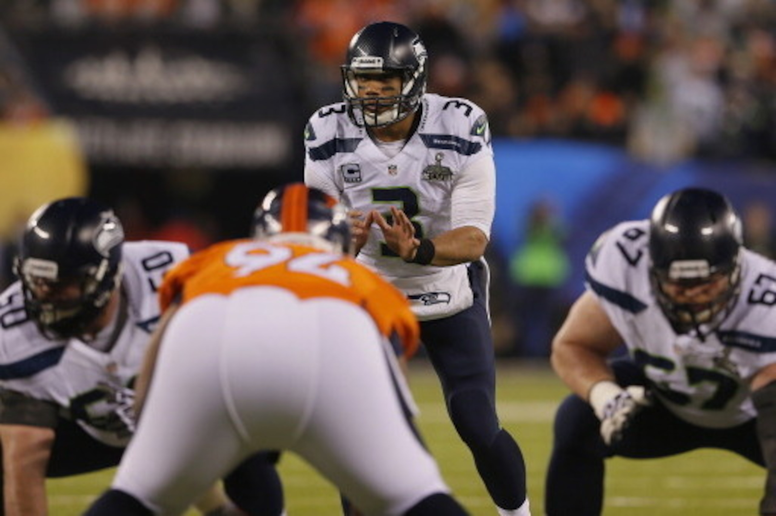 EAST RUTHERFORD, NJ - FEBRUARY 02:  Russell Wilson #3 of the Seattle Seahawks prepares to take the snap against the Denver Broncos during Super Bowl XLVIII at MetLife Stadium on February 2, 2014 in East Rutherford, New Jersey.  (Photo by Kevin C. Cox/Gett