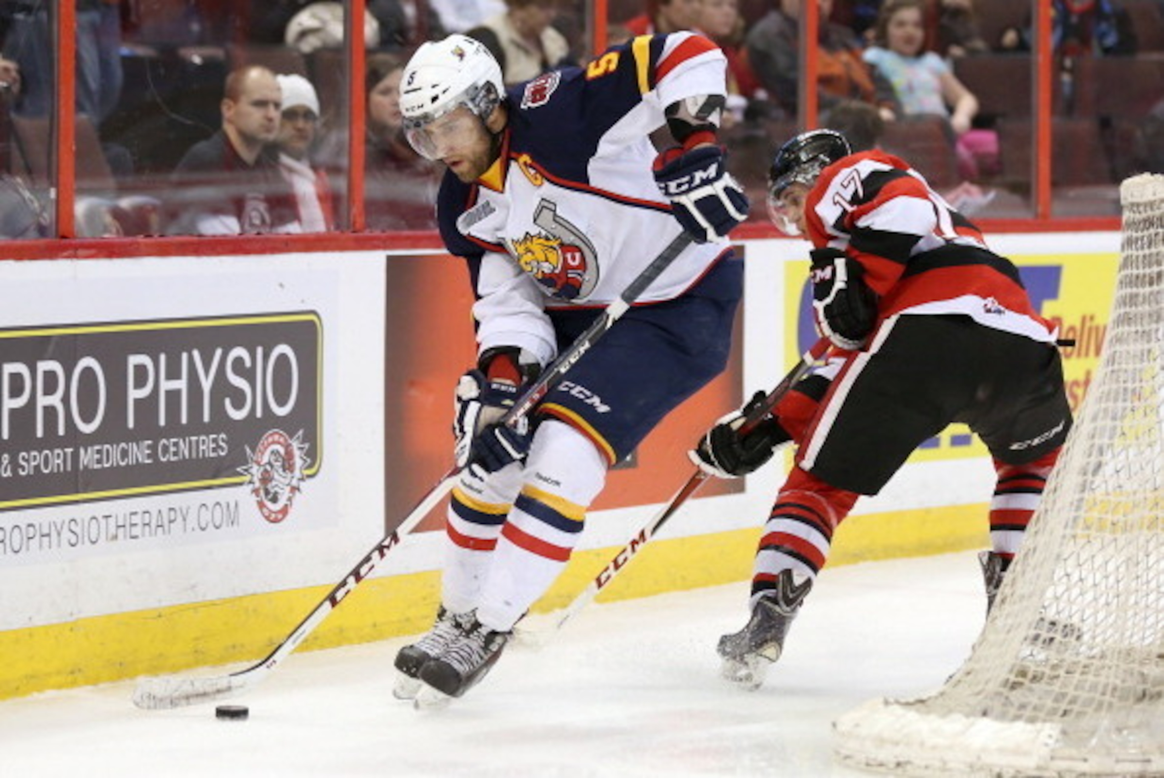 OTTAWA, ON - MARCH 13:  Aaron Ekblad #5 of the Barrie Colts skates with the puck past Travis Konecny #17 of the Ottawa 67's during an OHL game at Canadian Tire Centre on March 13, 2014 in Ottawa, Ontario, Canada.  (Photo by Jana Chytilova/Freestyle Photog