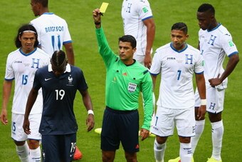 PORTO ALEGRE, BRAZIL - JUNE 15: Paul Pogba of France is shown a yellow card by referee Sandro Ricci during the 2014 FIFA World Cup Brazil Group E match between France and Honduras at Estadio Beira-Rio on June 15, 2014 in Porto Alegre, Brazil.  (Photo by P
