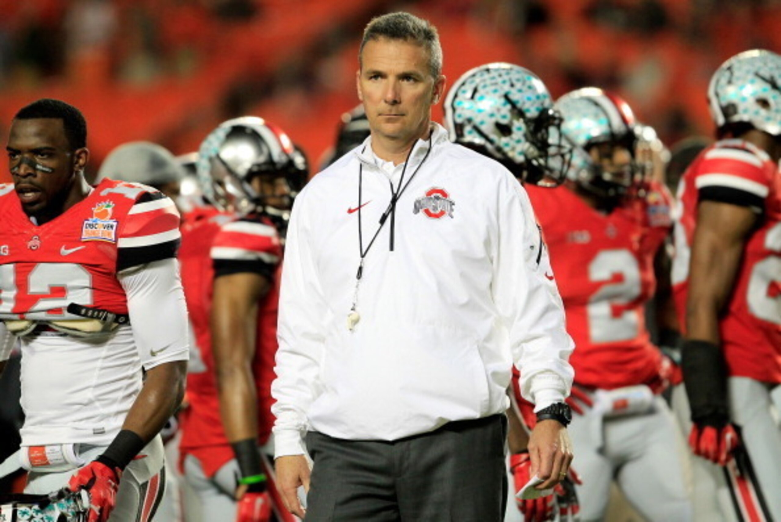 MIAMI GARDENS, FL - JANUARY 03:  Head coach Urban Meyer of the Ohio State Buckeyes looks on during warm ups prior to the Discover Orange Bowl against the Clemson Tigers at Sun Life Stadium on January 3, 2014 in Miami Gardens, Florida.  (Photo by Chris Tro