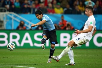 SAO PAULO, BRAZIL - JUNE 19: Luis Suarez of Uruguay scores his team's second goal against Gary Cahill of England during the 2014 FIFA World Cup Brazil Group D match between Uruguay and England at Arena de Sao Paulo on June 19, 2014 in Sao Paulo, Brazil.  