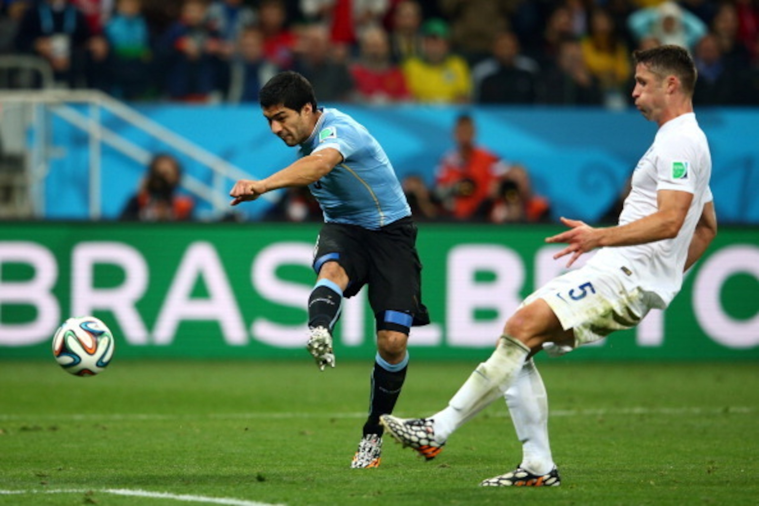 SAO PAULO, BRAZIL - JUNE 19: Luis Suarez of Uruguay scores his team's second goal against Gary Cahill of England during the 2014 FIFA World Cup Brazil Group D match between Uruguay and England at Arena de Sao Paulo on June 19, 2014 in Sao Paulo, Brazil.  