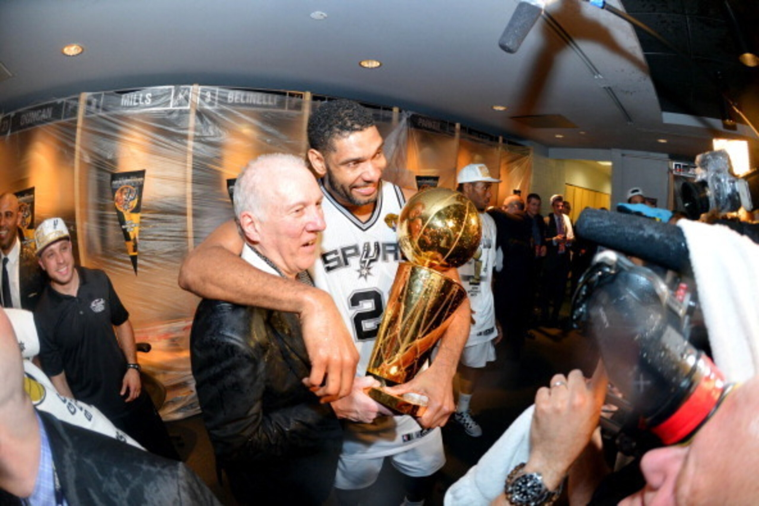 SAN ANTONIO, TX - JUNE 15: Head Coach Gregg Popovich and Tim Duncan #21 of the San Antonio Spurs celebrate in the locker room with the Larry O'Brien trophy after defeating the Miami Heat to win the 2014 NBA Finals in Game Five of the 2014 NBA Finals on Ju