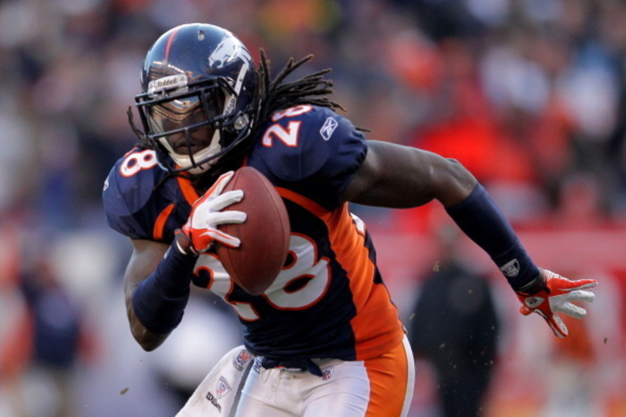 DENVER, CO - JANUARY 08: Quinton Carter #28 of the Denver Broncos runs with the ball against the Pittsburgh Steelers during the AFC Wild Card Playoff game at Sports Authority Field at Mile High on January 8, 2012 in Denver, Colorado. (Photo by Doug Pens DENVER, CO - JANUARY 08: Quinton Carter #28 of the Denver Broncos runs with the ball against the Pittsburgh Steelers during the AFC Wild Card Playoff game at Sports Authority Field at Mile High on January 8, 2012 in Denver, Colorado. (Photo by Doug Pens