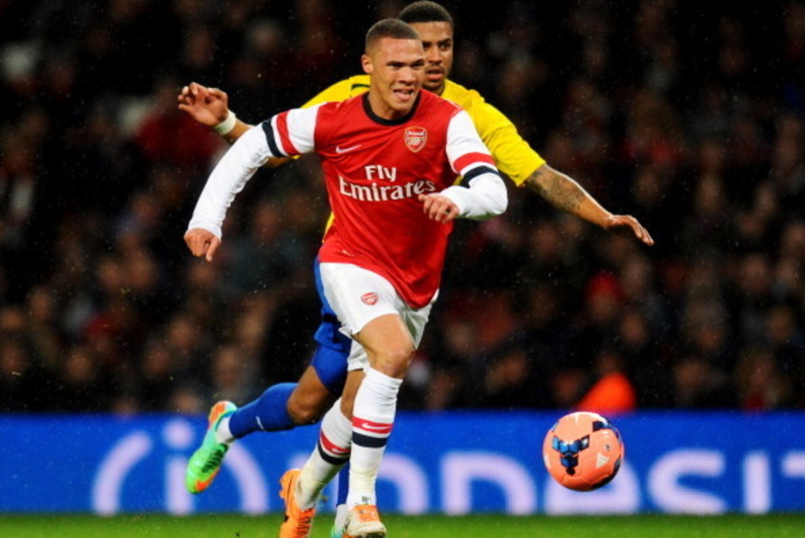 LONDON, ENGLAND - JANUARY 24:  Kieran Gibbs of Arsenal chases the ball with Cyrus Christie of Coventry City during the FA Cup with Budweiser Fourth round match between Arsenal and Coventry City at Emirates Stadium on January 24, 2014 in London, England.  