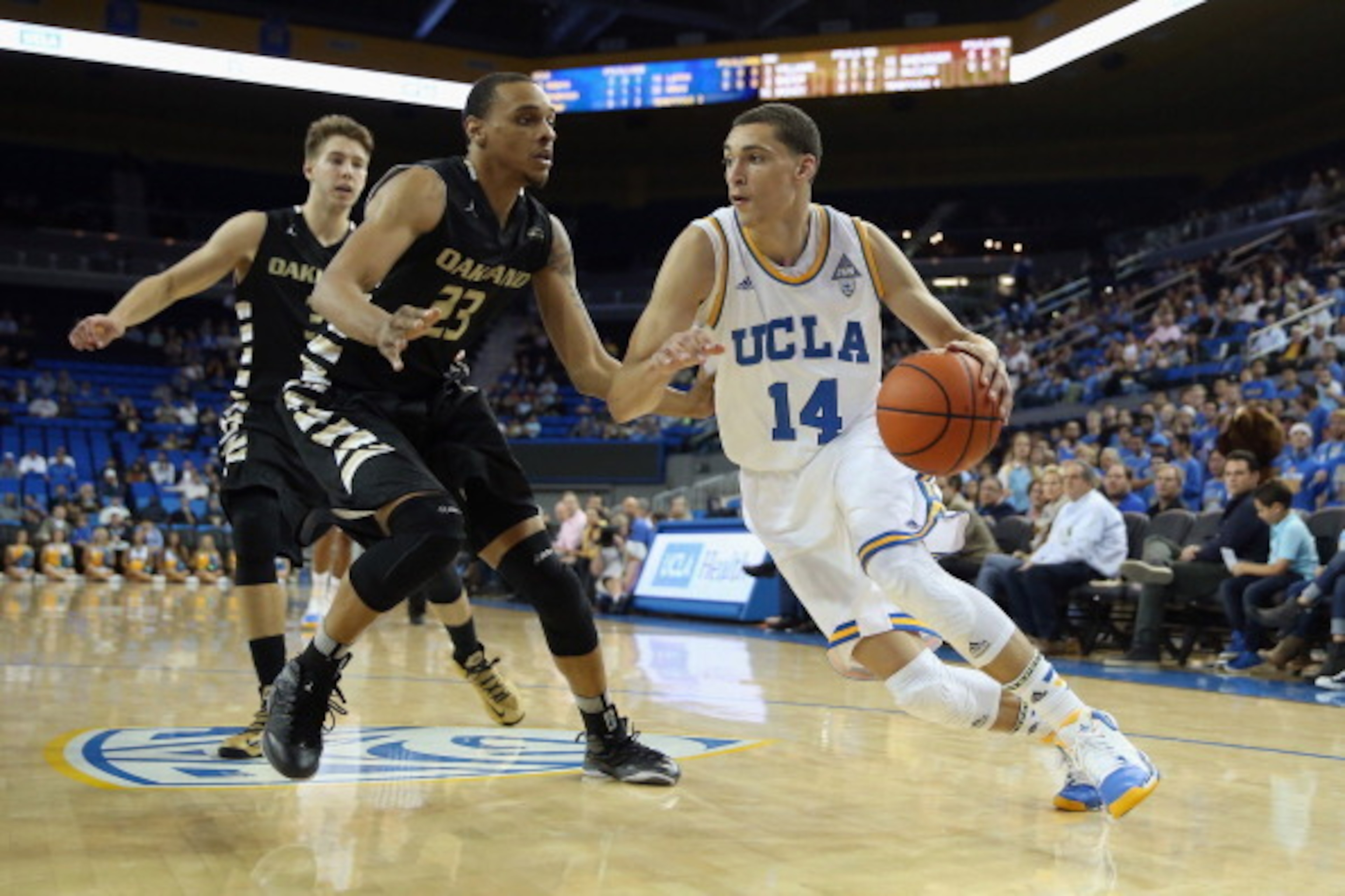LOS ANGELES, CA - NOVEMBER 12:  Zach LaVine #14 of the UCLA Bruins drives to the basket past Tommie McCune #23 of the Oakland Golden Grizzlies in the first half at Pauley Pavilion on November 12, 2013 in Los Angeles, California.  (Photo by Jeff Gross/Gett