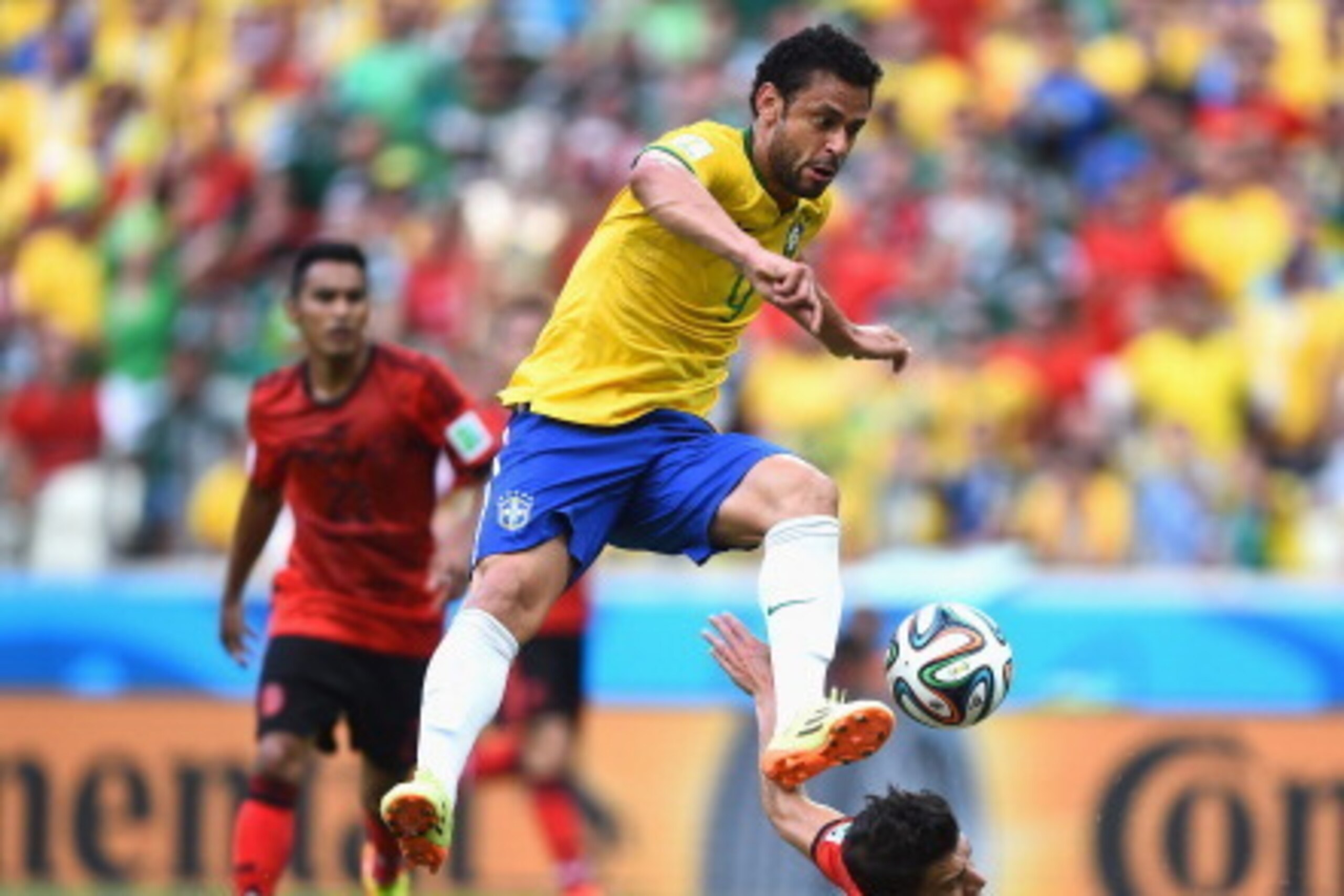 FORTALEZA, BRAZIL - JUNE 17: Fred of Brazil has his shot blocked by Hector Moreno of Mexico at Castelao on June 17, 2014 in Fortaleza, Brazil.  (Photo by Laurence Griffiths/Getty Images)