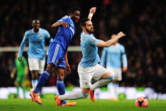 MANCHESTER, ENGLAND - FEBRUARY 15:  Alvaro Negredo (R) of Manchester City is tackled by Jon Obi Mikel (L) of Chelsea during the FA Cup Fifth Round match between Manchester City and Chelsea at the Etihad Stadium on February 15, 2014 in Manchester, England.