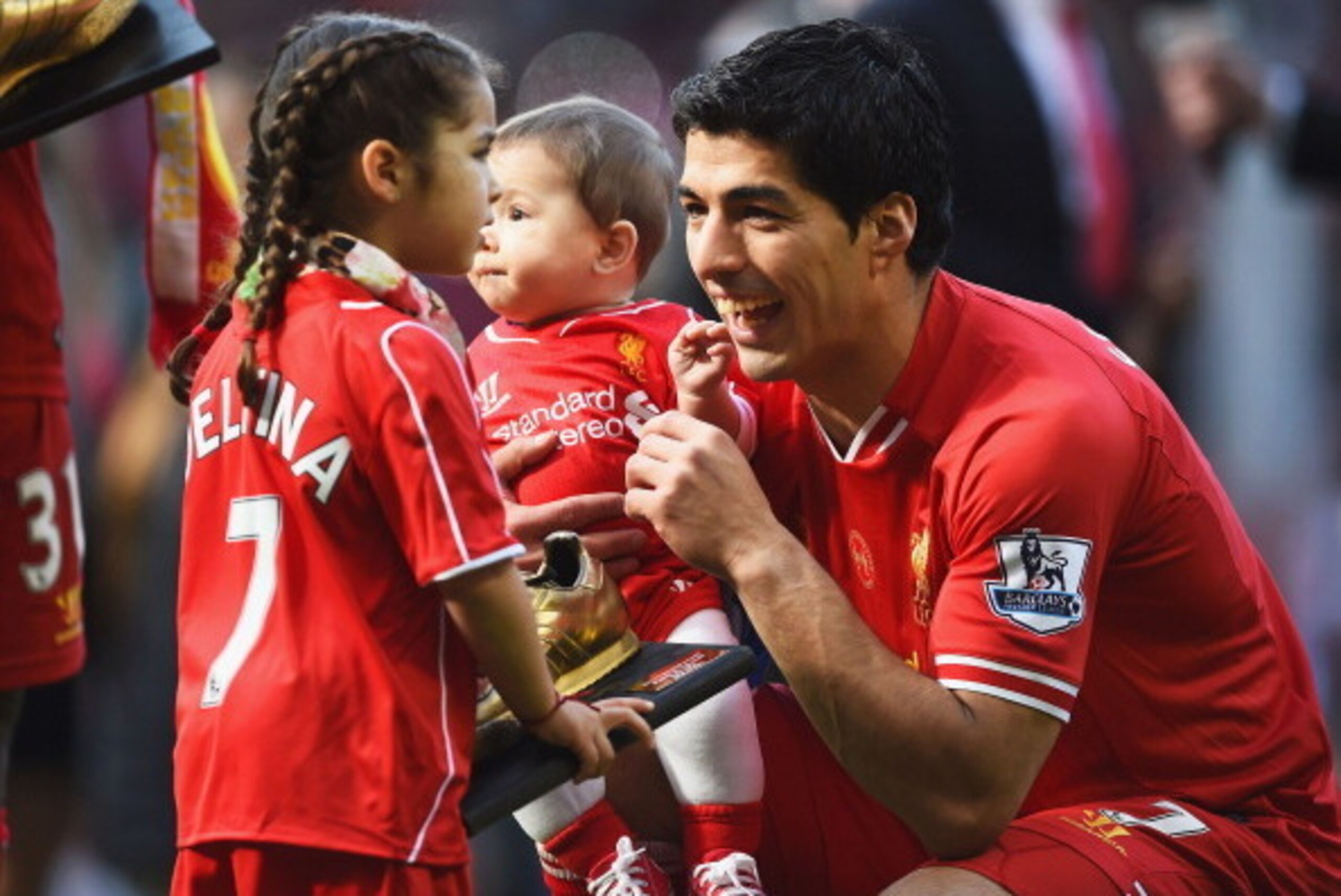LIVERPOOL, ENGLAND - MAY 11:  Luis Suarez of Liverpool with his children Delfina and Benjamin after the Barclays Premier League match between Liverpool and Newcastle United at Anfield on May 11, 2014 in Liverpool, England. Liverpool finish as runners-up i