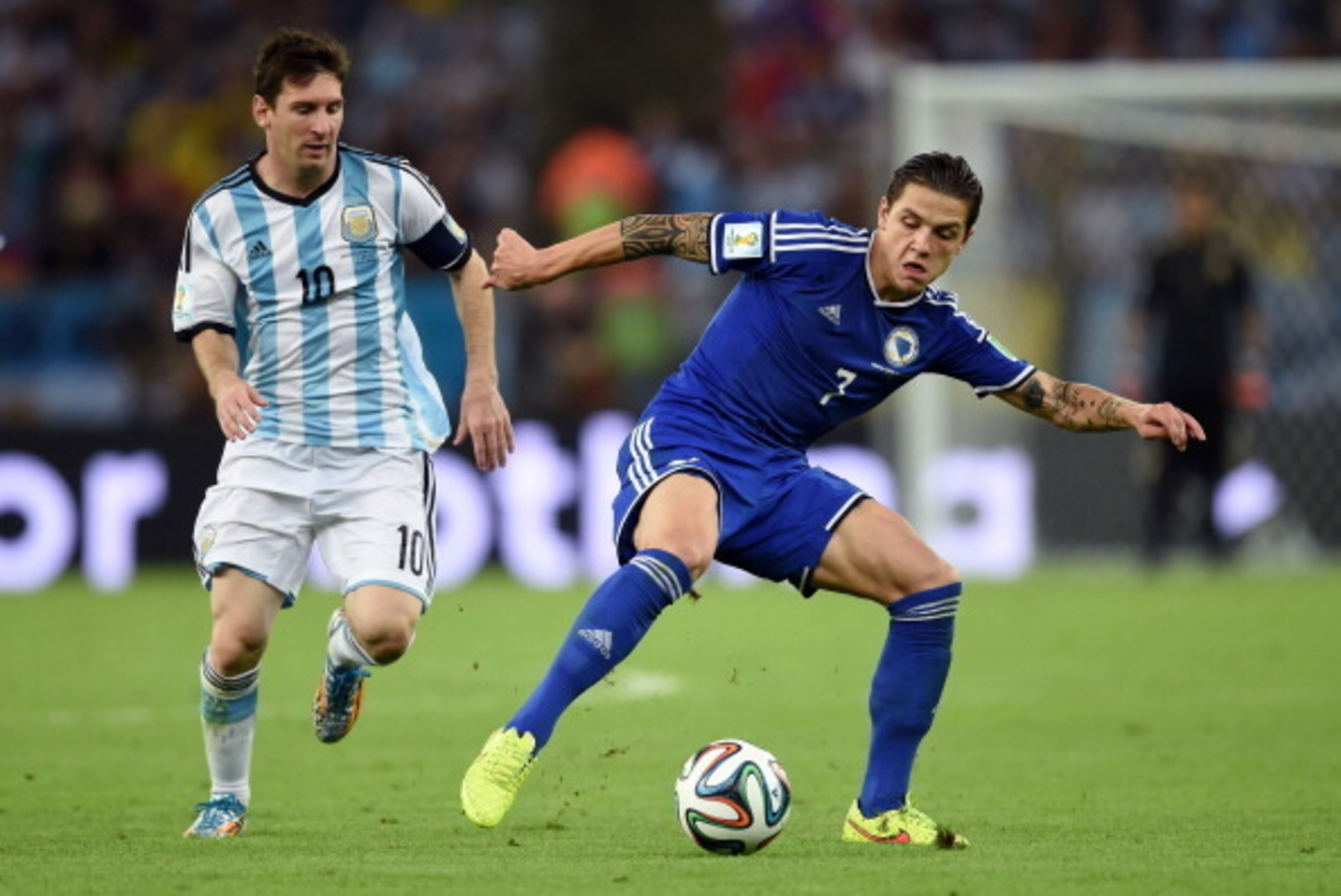 RIO DE JANEIRO, BRAZIL - JUNE 15: Muhamed Besic of Bosnia and Herzegovina controls the ball against Lionel Messi of Argentina during the 2014 FIFA World Cup Brazil Group F match between Argentina and Bosnia-Herzegovina at Maracana on June 15, 2014 in Rio 