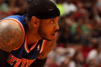 MIAMI, FL - April 6: Carmelo Anthony #7 of the New York Knicks looks on while on the court during the game against the Miami Heat at the American Airlines Arena in Miami, Florida on April 6, 2014. NOTE TO USER: User expressly acknowledges and agrees that,