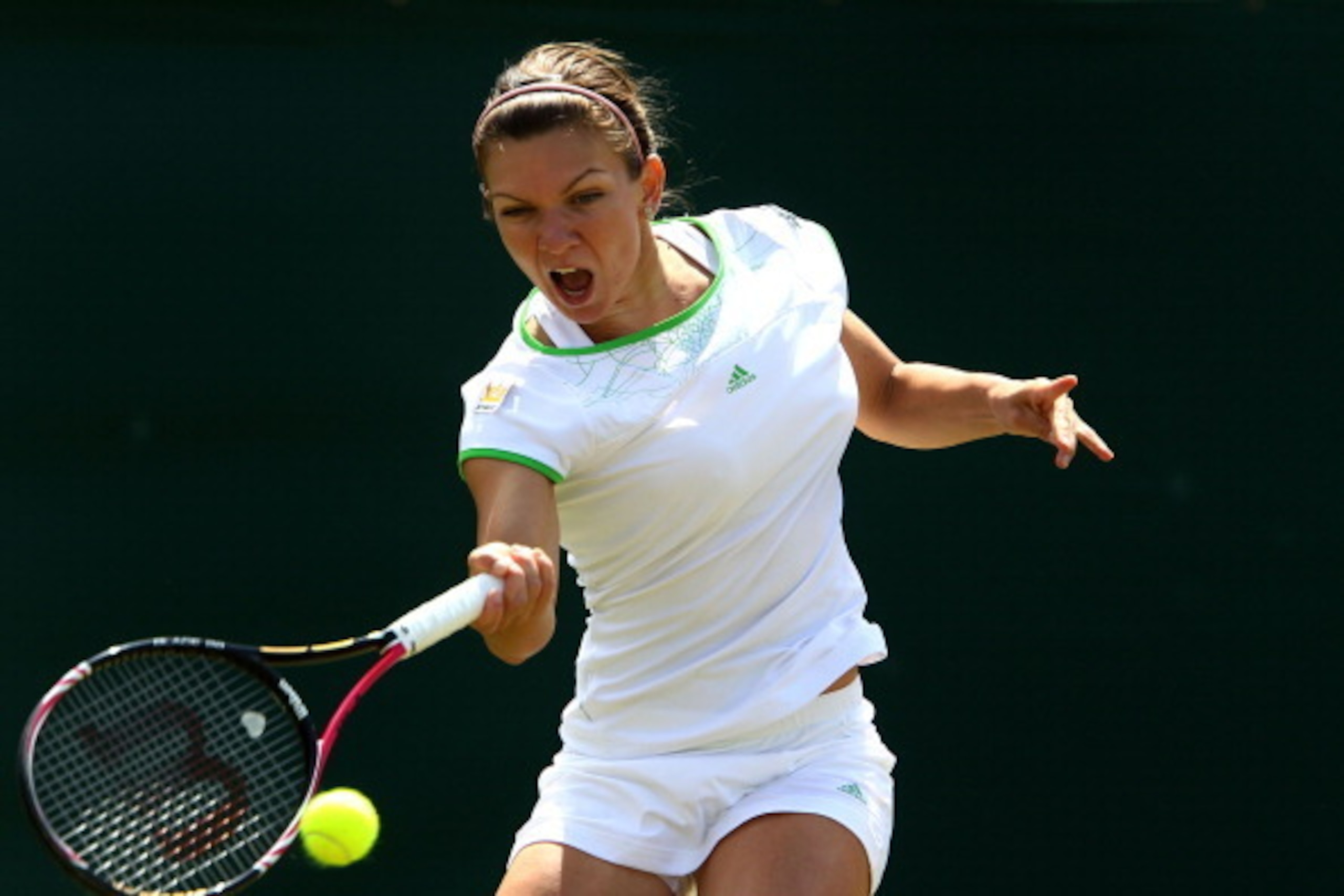 LONDON, ENGLAND - JUNE 23: Simona Halep of Romania returns a shot during her second round match against Serena Williams of the United States on Day Four of the Wimbledon Lawn Tennis Championships at the All England Lawn Tennis and Croquet Club on June 23 LONDON, ENGLAND - JUNE 23: Simona Halep of Romania returns a shot during her second round match against Serena Williams of the United States on Day Four of the Wimbledon Lawn Tennis Championships at the All England Lawn Tennis and Croquet Club on June 23