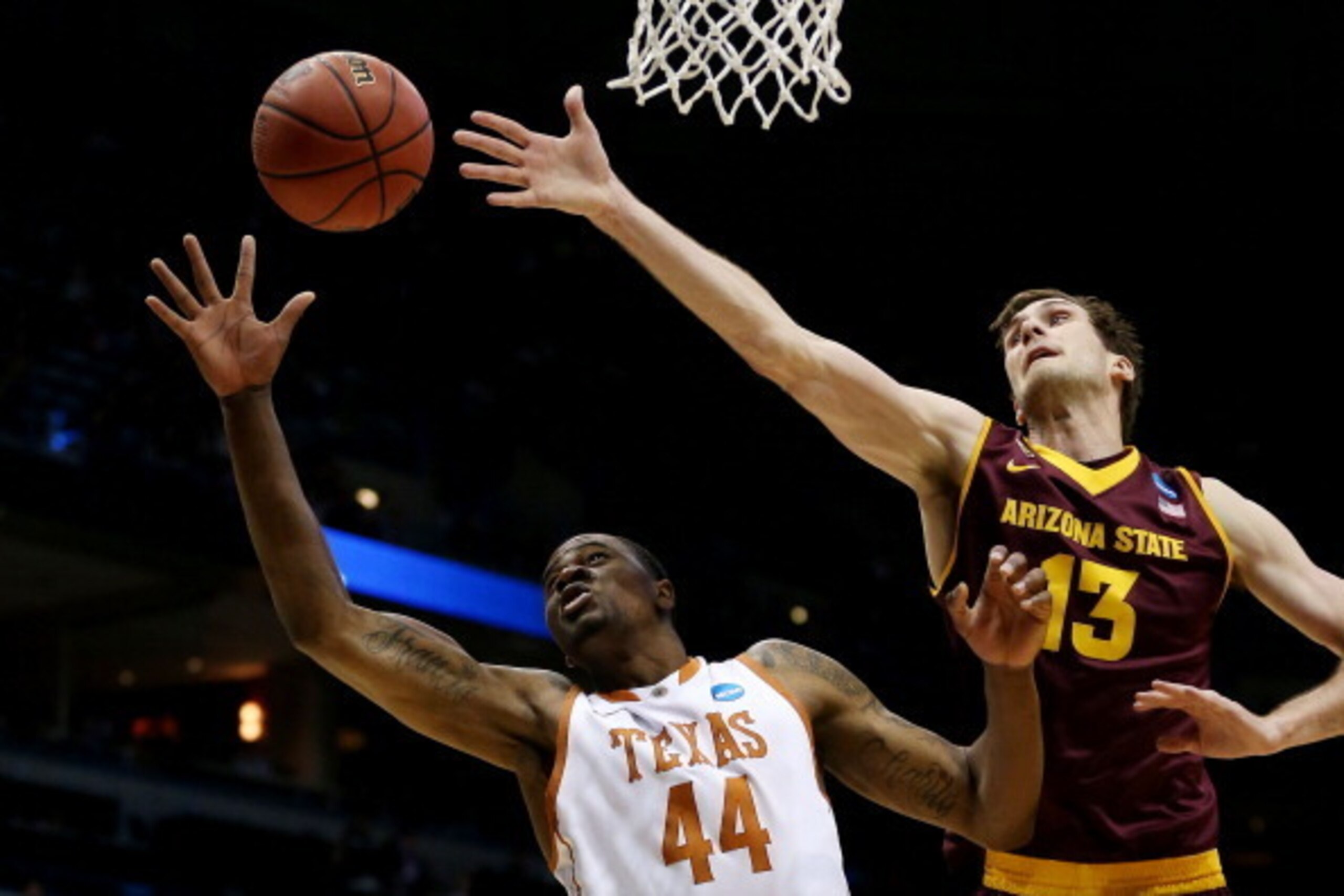 MILWAUKEE, WI - MARCH 20: Prince Ibeh #44 of the Texas Longhorns and Jordan Bachynski #13 of the Arizona State Sun Devils vie for a rebound in the first half during the second round of the 2014 NCAA Men's Basketball Tournament at BMO Harris Bradley Cente MILWAUKEE, WI - MARCH 20: Prince Ibeh #44 of the Texas Longhorns and Jordan Bachynski #13 of the Arizona State Sun Devils vie for a rebound in the first half during the second round of the 2014 NCAA Men's Basketball Tournament at BMO Harris Bradley Cente