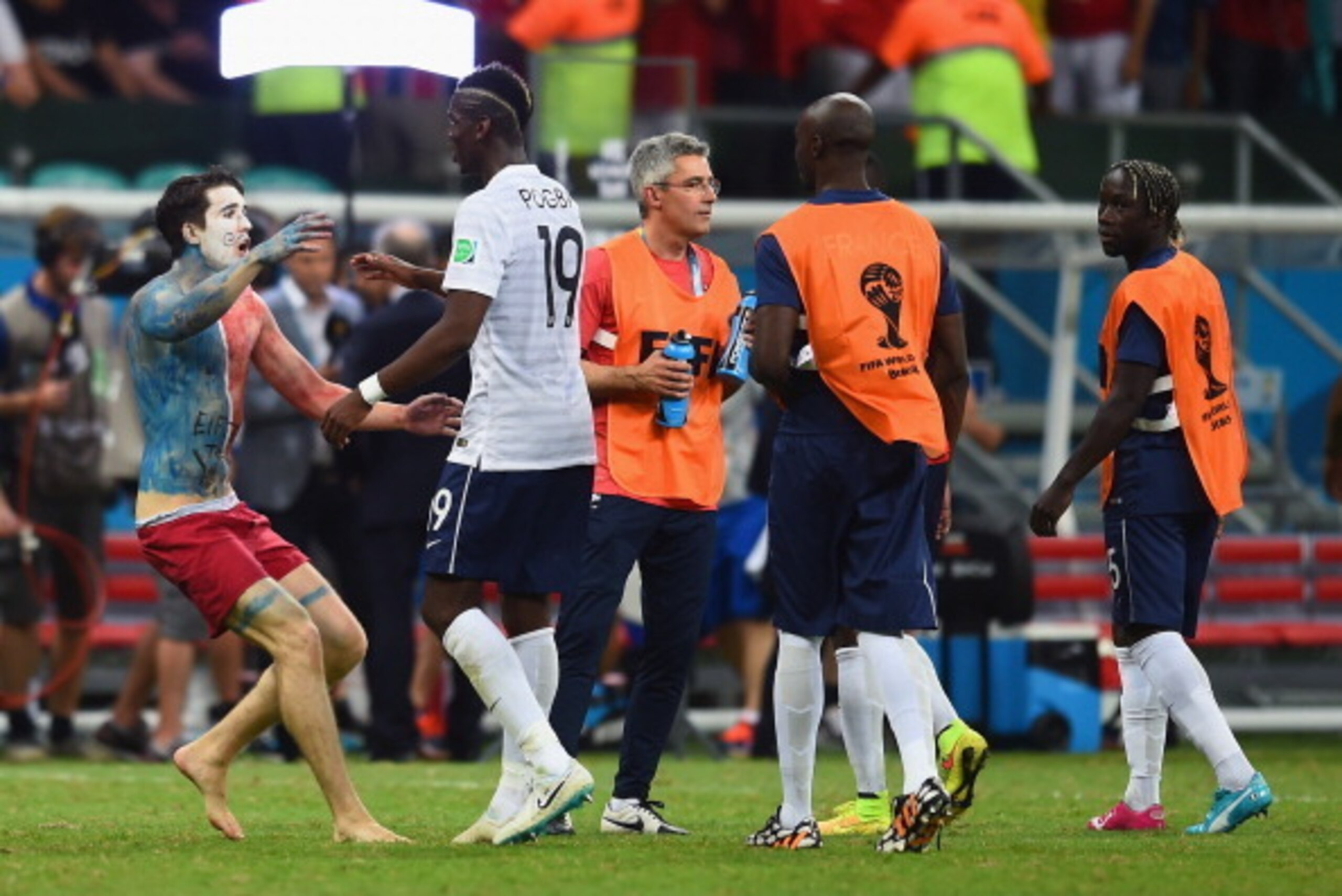 SALVADOR, BRAZIL - JUNE 20: A pitch invader runs toward Paul Pogba of France during the 2014 FIFA World Cup Brazil Group E match between Switzerland and France at Arena Fonte Nova on June 20, 2014 in Salvador, Brazil. (Photo by Christopher Lee/Getty Imag SALVADOR, BRAZIL - JUNE 20: A pitch invader runs toward Paul Pogba of France during the 2014 FIFA World Cup Brazil Group E match between Switzerland and France at Arena Fonte Nova on June 20, 2014 in Salvador, Brazil. (Photo by Christopher Lee/Getty Imag
