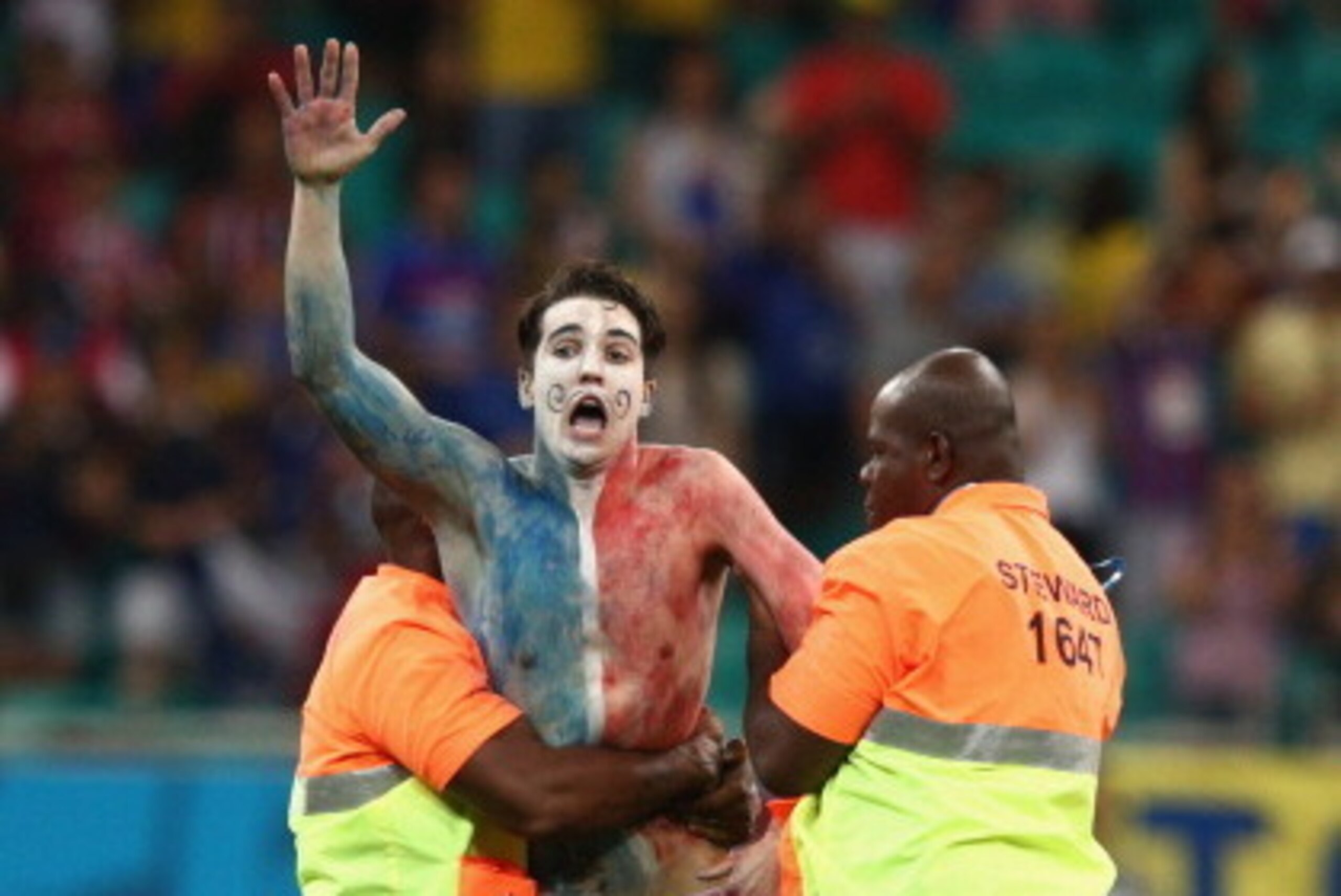 SALVADOR, BRAZIL - JUNE 20: Security personnel escort a pitch invader after the match during the 2014 FIFA World Cup Brazil Group E match between Switzerland and France at Arena Fonte Nova on June 20, 2014 in Salvador, Brazil. (Photo by Adam Pretty/Gett SALVADOR, BRAZIL - JUNE 20: Security personnel escort a pitch invader after the match during the 2014 FIFA World Cup Brazil Group E match between Switzerland and France at Arena Fonte Nova on June 20, 2014 in Salvador, Brazil. (Photo by Adam Pretty/Gett
