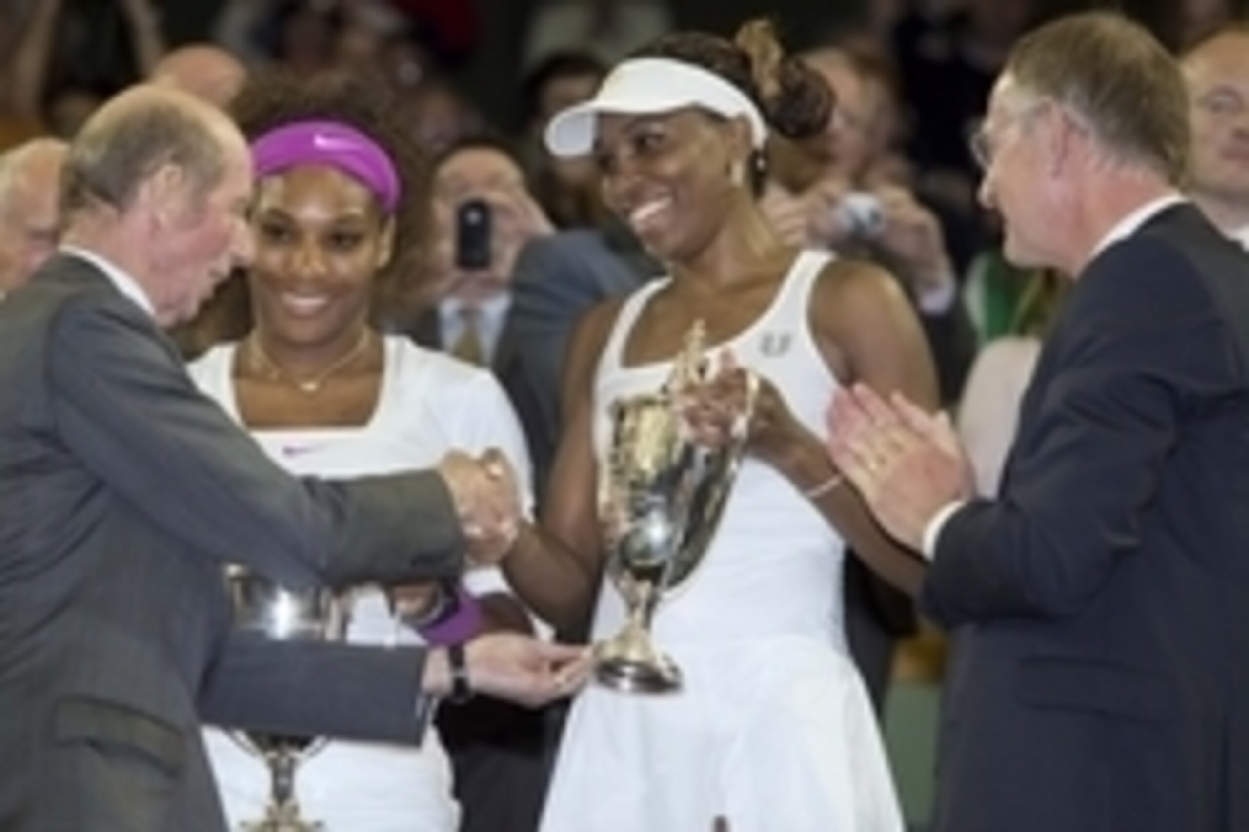 July 7, 2012; London, UNITED KINGDOM; Serena Williams (USA), left, and Venus Williams (USA) are presented with trophies after defeating Andrea Hlavackova (CZE) and Lucie Hradecka (CZE) in the women's doubles finals of the 2012 Wimbledon Championships at t