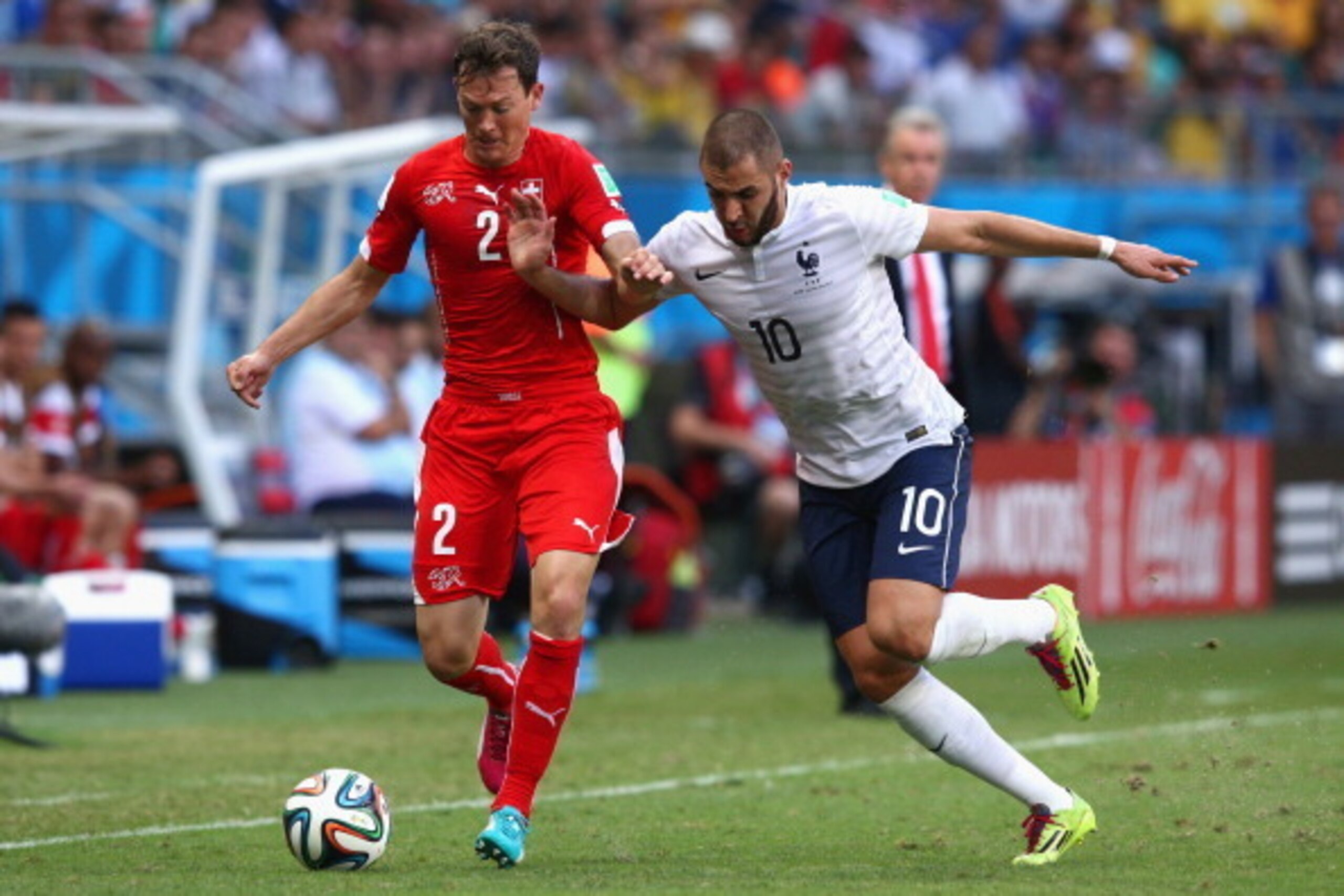 SALVADOR, BRAZIL - JUNE 20: Stephan Lichtsteiner of Switzerland controls the ball against Karim Benzema of France during the 2014 FIFA World Cup Brazil Group E match between Switzerland and France at Arena Fonte Nova on June 20, 2014 in Salvador, Brazil. SALVADOR, BRAZIL - JUNE 20: Stephan Lichtsteiner of Switzerland controls the ball against Karim Benzema of France during the 2014 FIFA World Cup Brazil Group E match between Switzerland and France at Arena Fonte Nova on June 20, 2014 in Salvador, Brazil.