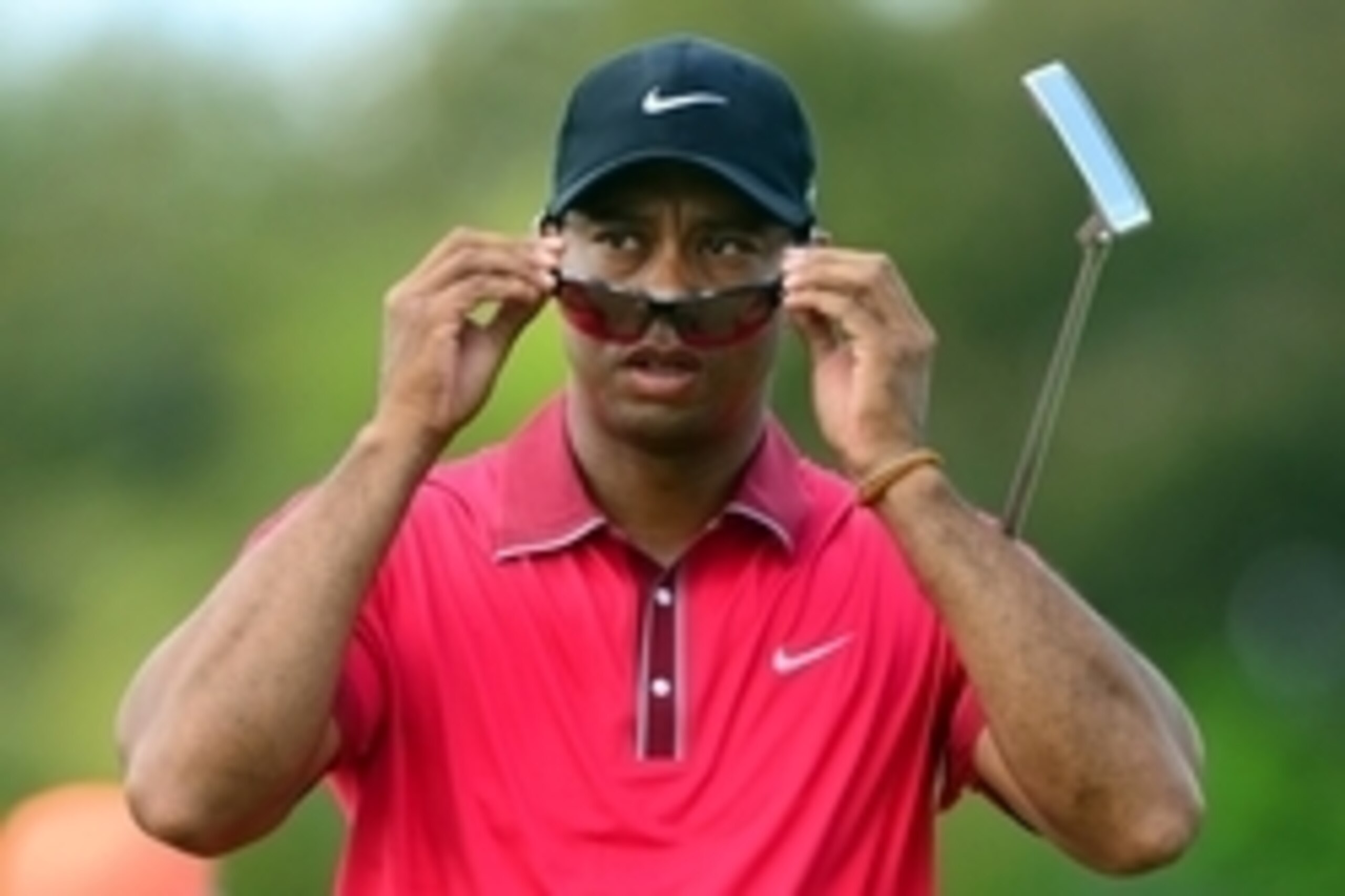 Mar 9, 2014; Miami, FL, USA; Tiger Woods puts on his sunglasses on the 3rd hole green during the final round of the WGC - Cadillac Championship golf tournament at TPC Blue Monster at Trump National Doral. Mandatory Credit: Andrew Weber-USA TODAY Sports