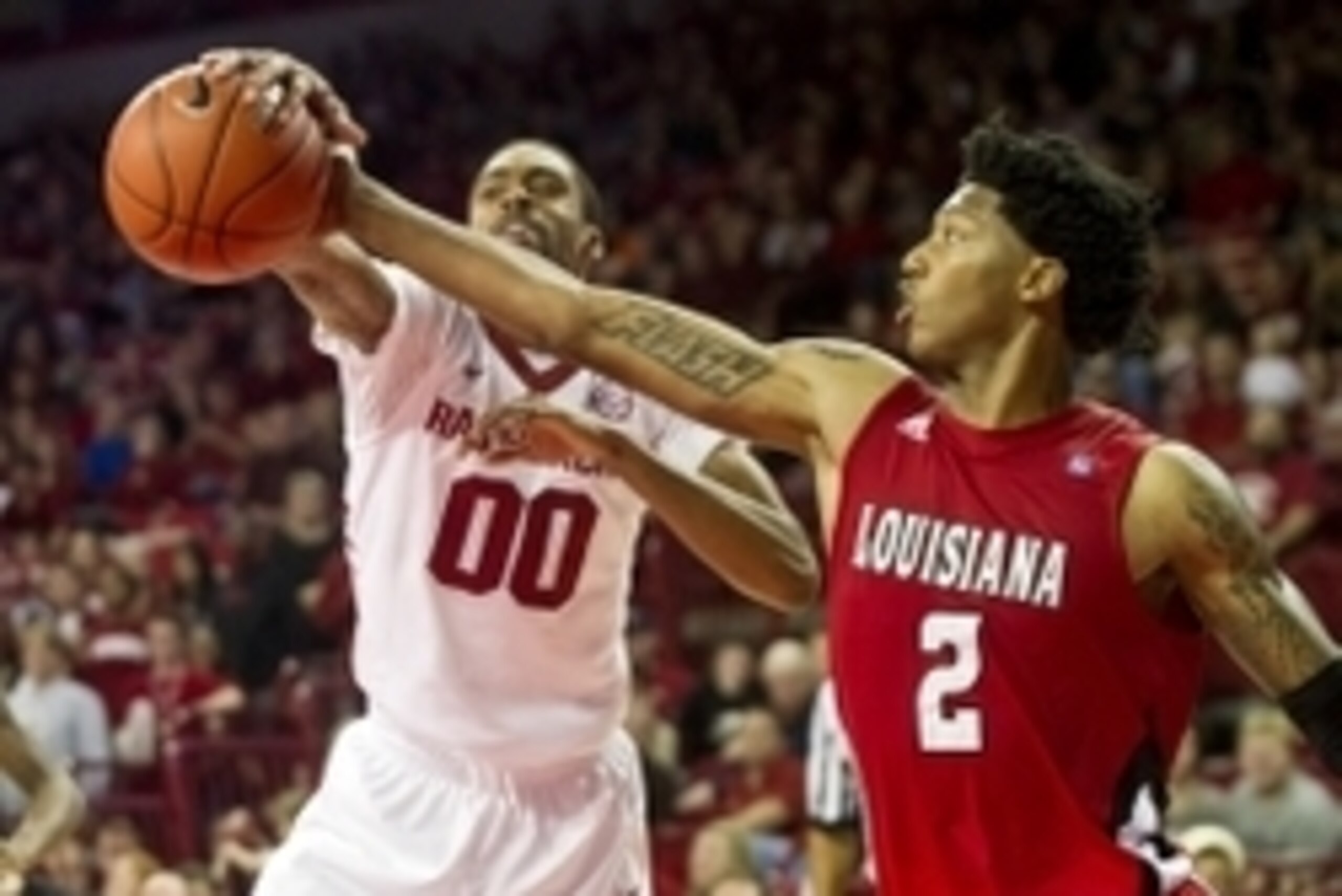 Nov 15, 2013; Fayetteville, Ar, USA; Louisiana-Lafayette Ragin' Cajuns guard Elfrid Payton (2) and Arkansas Razorback guard Rashad Madden (00) battle for control of a rebound during the second half at Bud Walton Arena Arena. Arkansas defeated Louisiana-La