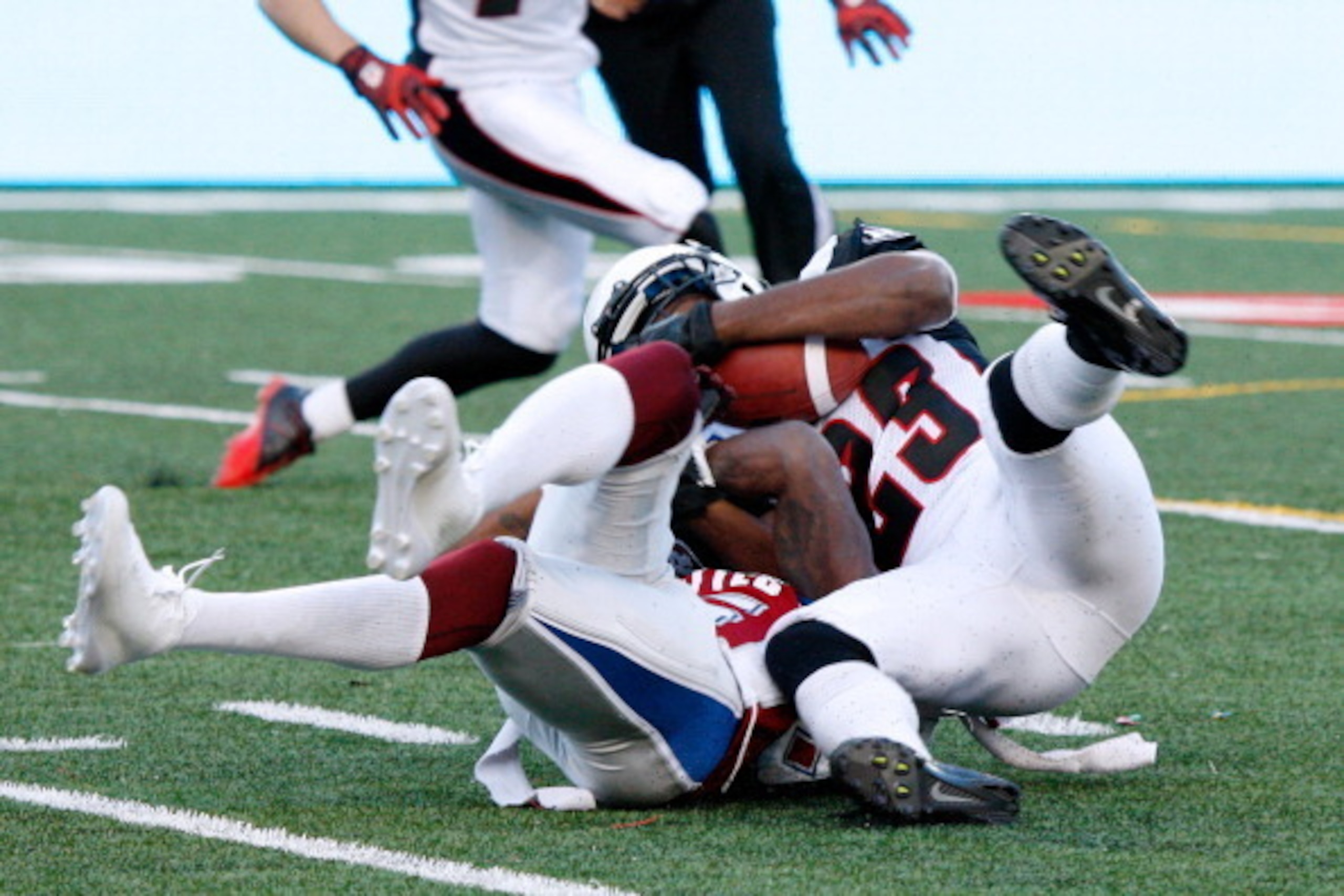 MONTREAL, QC - JUNE 20:  Seth Williams #23 of the Ottawa Redblacks tackles Chad Johnson #85 of the Montreal Alouettes during the CFL game at Percival Molson Stadium on June 20, 2014 in Montreal, Quebec, Canada.  The Redblacks defeated the Alouettes 26-10.