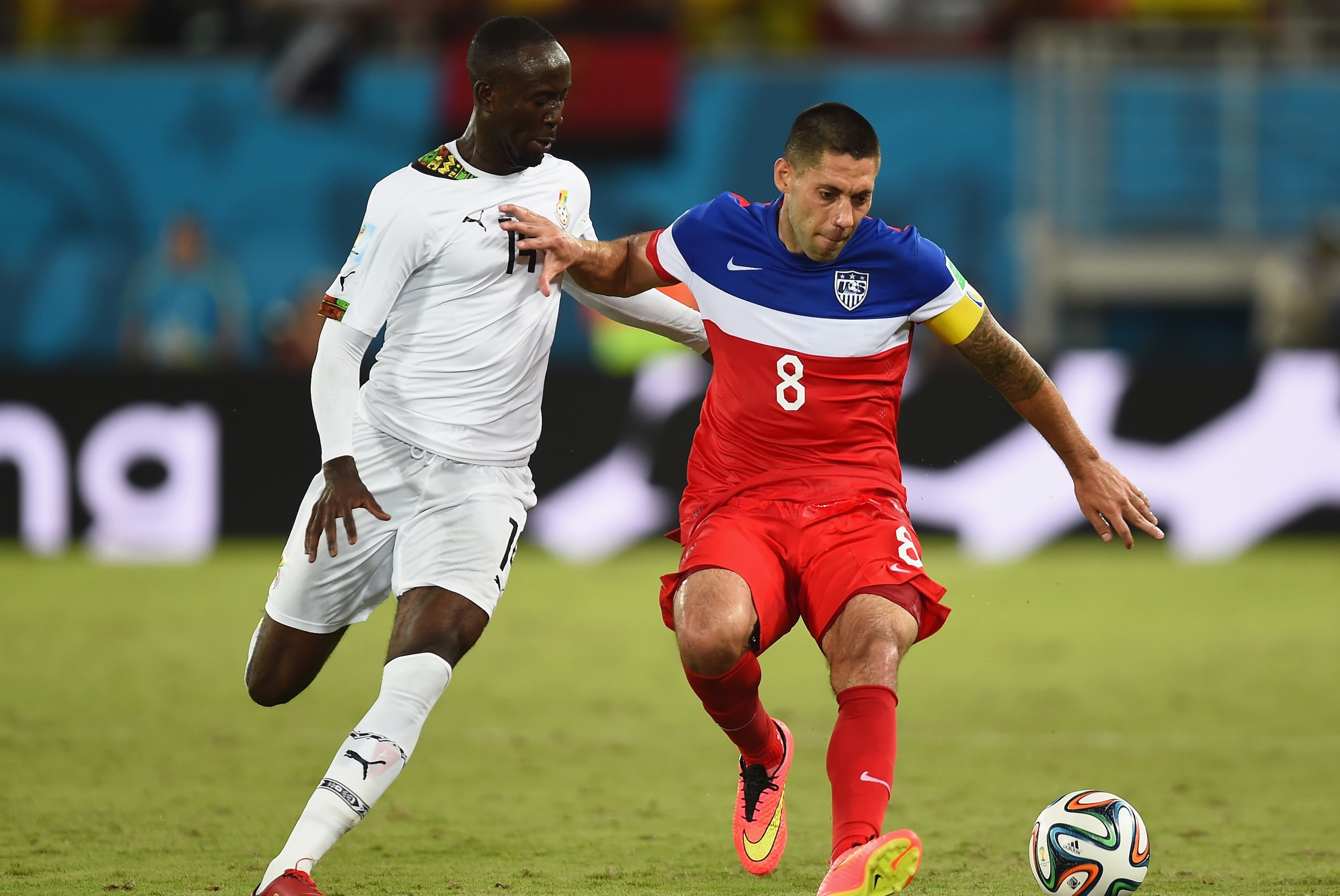 NATAL, BRAZIL - JUNE 16: Clint Dempsey of the United States holds off a challenge by Albert Adomah of Ghana during the 2014 FIFA World Cup Brazil Group G match between Ghana and the United States at Estadio das Dunas on June 16, 2014 in Natal, Brazil.  (P