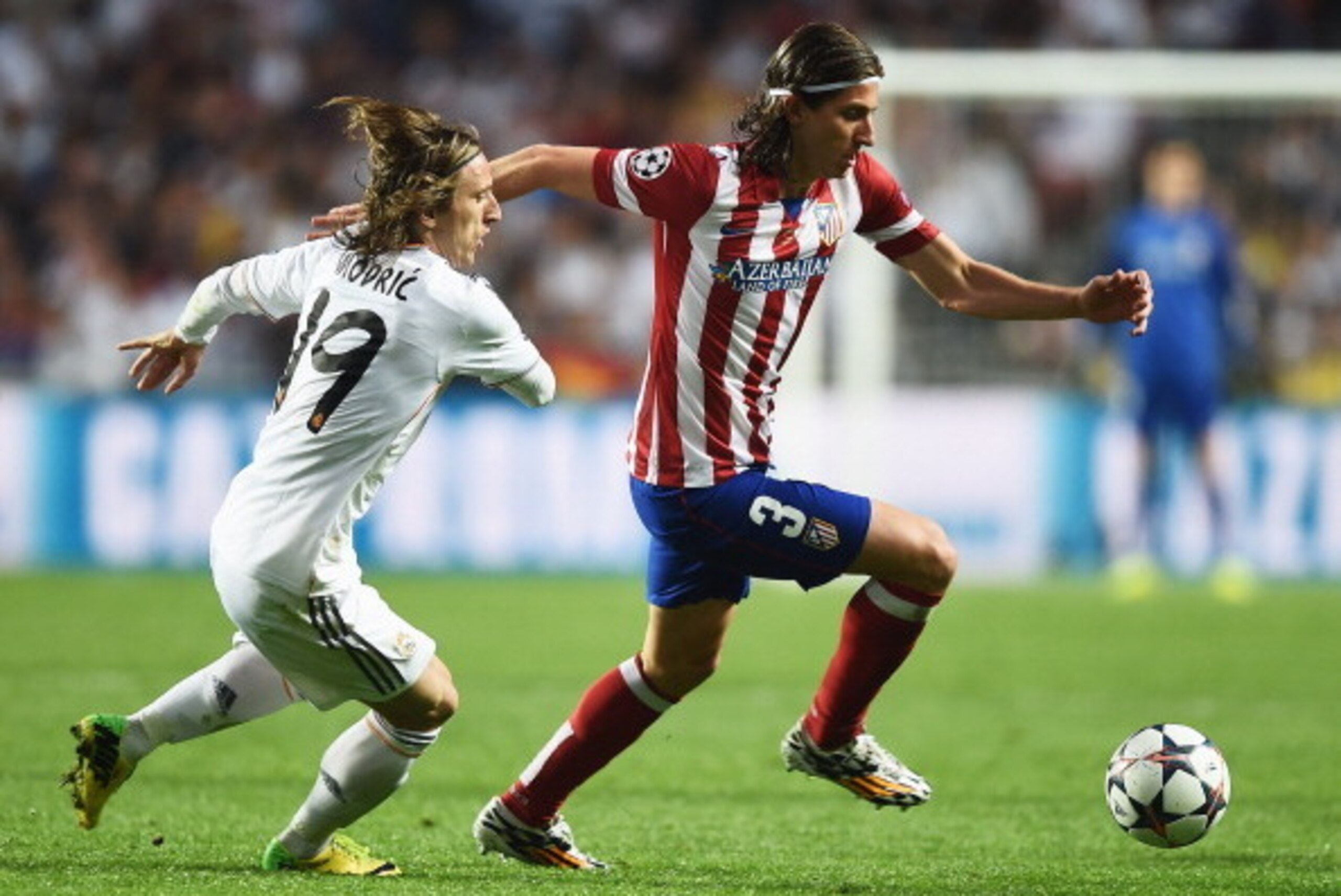 LISBON, PORTUGAL - MAY 24: Filipe Luis of Club Atletico de Madrid takes on Luka Modric of Real Madrid during the UEFA Champions League Final between Real Madrid and Atletico de Madrid at Estadio da Luz on May 24, 2014 in Lisbon, Portugal. (Photo by Laur LISBON, PORTUGAL - MAY 24: Filipe Luis of Club Atletico de Madrid takes on Luka Modric of Real Madrid during the UEFA Champions League Final between Real Madrid and Atletico de Madrid at Estadio da Luz on May 24, 2014 in Lisbon, Portugal. (Photo by Laur