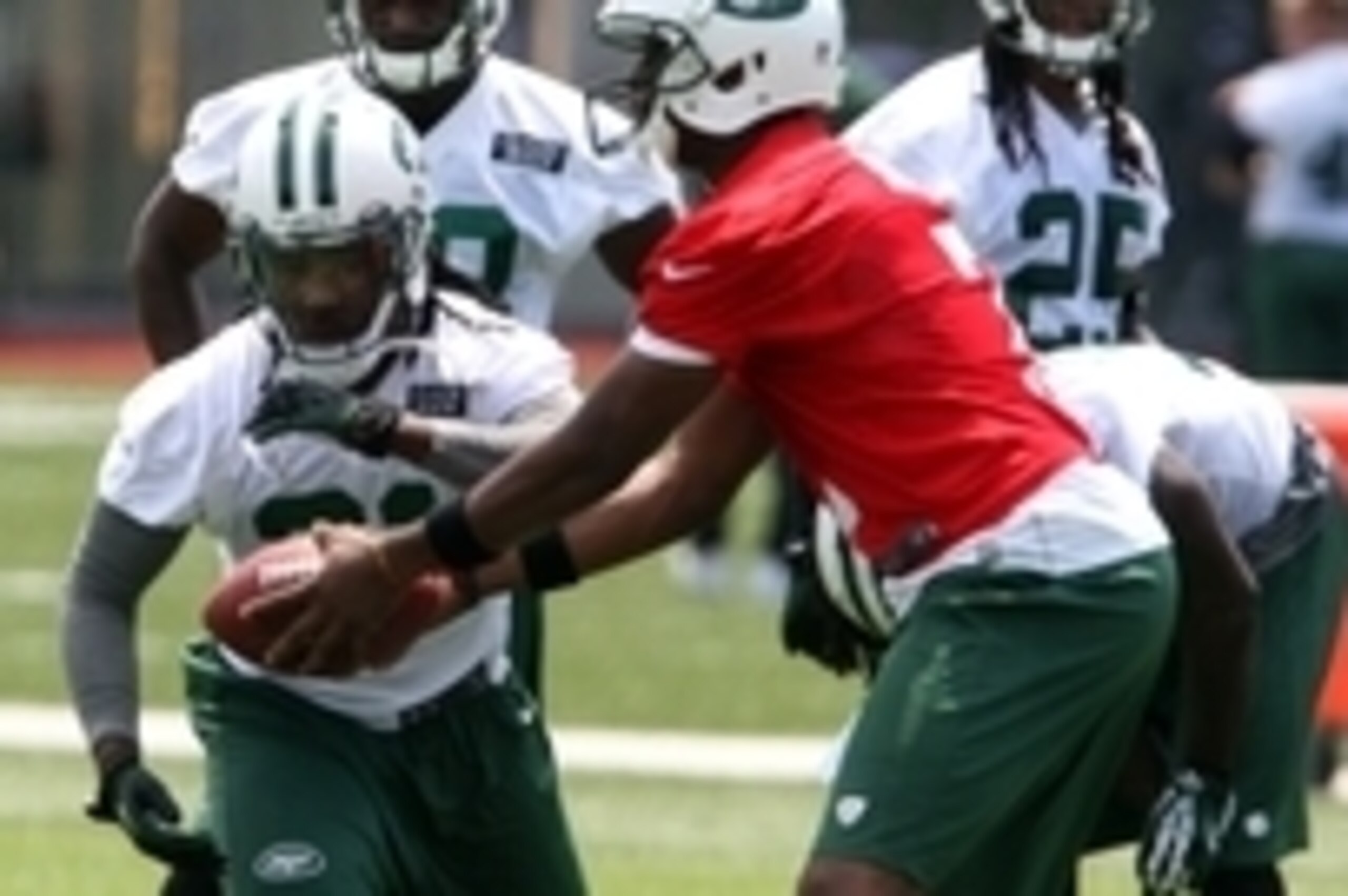 Jun 17, 2014; Florham Park, NJ, USA; New York Jets running back Chris Johnson (left) takes a hand off from New York Jets quarterback Geno Smith (7) during minicamp at Atlantic Health Training Center. Mandatory Credit: Noah K. Murray-USA TODAY Sports